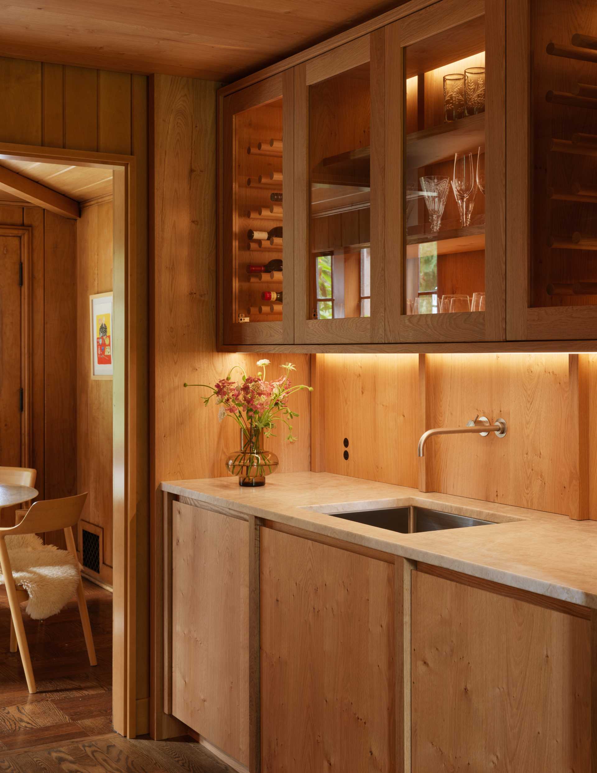 A contemporary butler's pantry with wood cabinets.