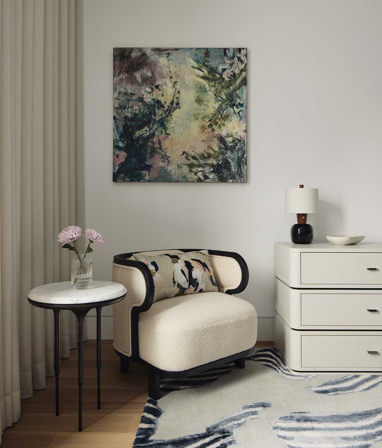 A modern primary bedroom with deep blues, textures, and subtle wallpaper.