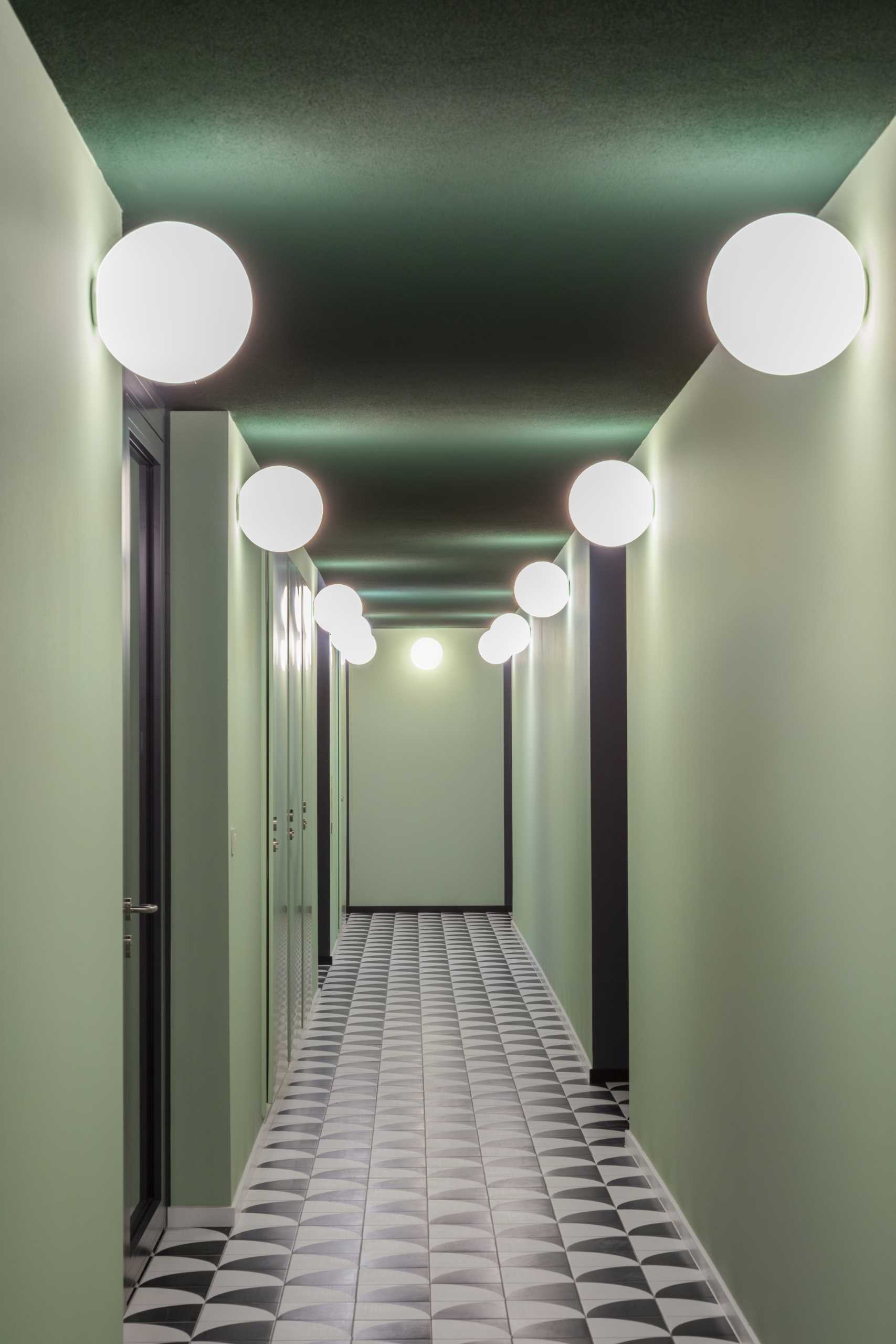 A modern residential building a mint green interior that matches the tiled facade.