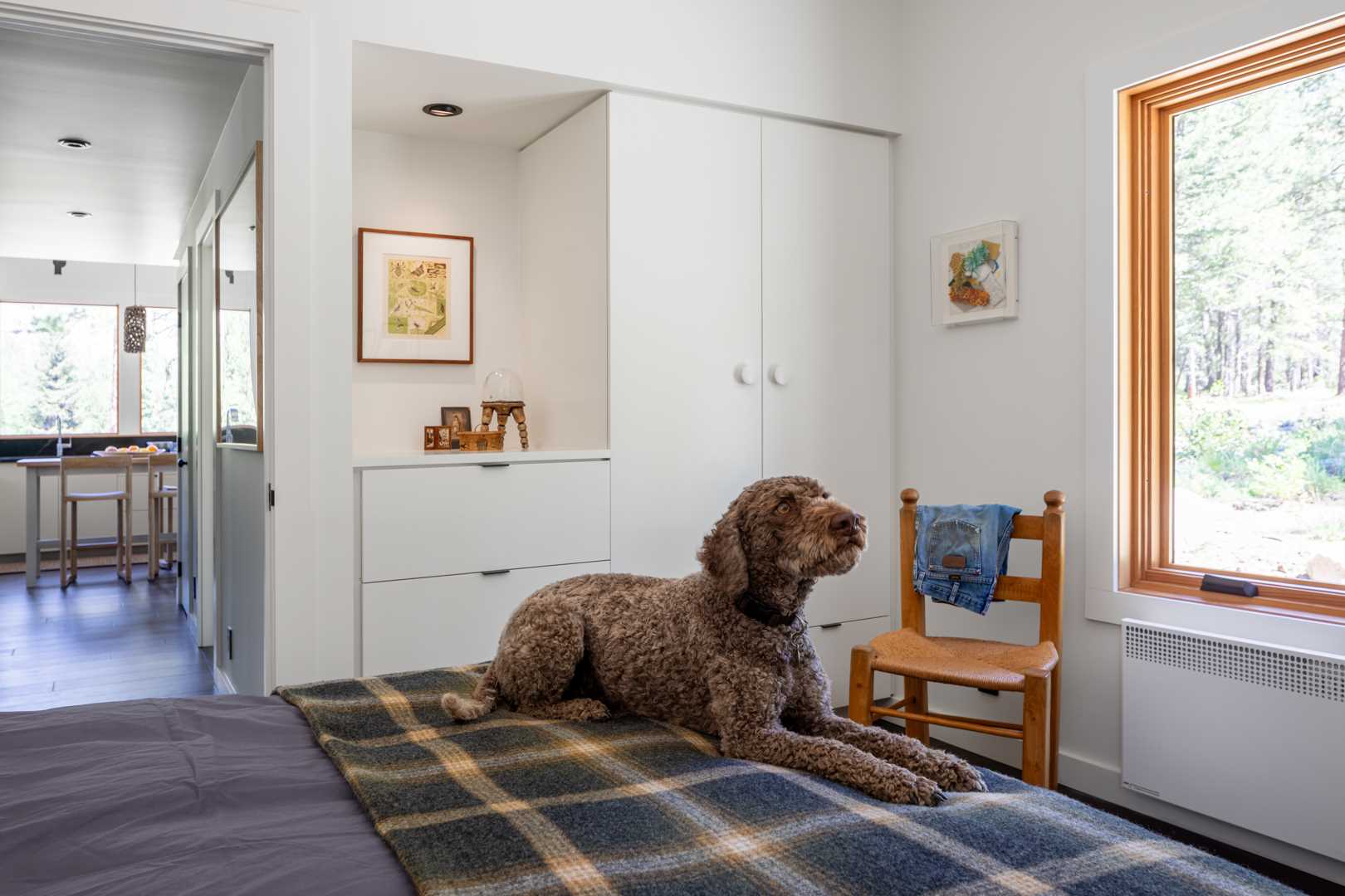 In this bedroom, simple furnishings have been paired with the owner’s collection of art, family heirlooms, and furniture gathered over many years.