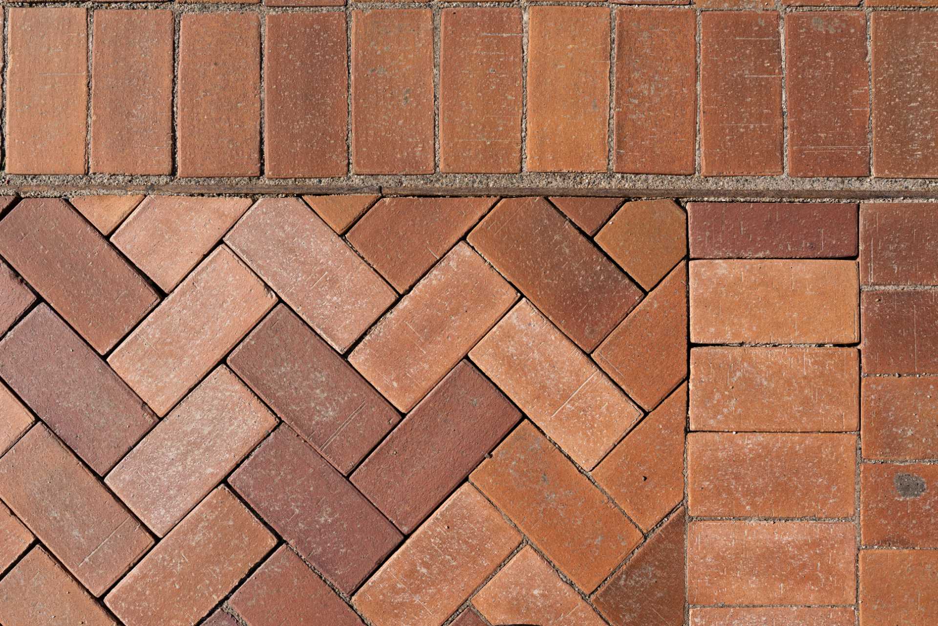 The brick paving and landscaping around a charging station.