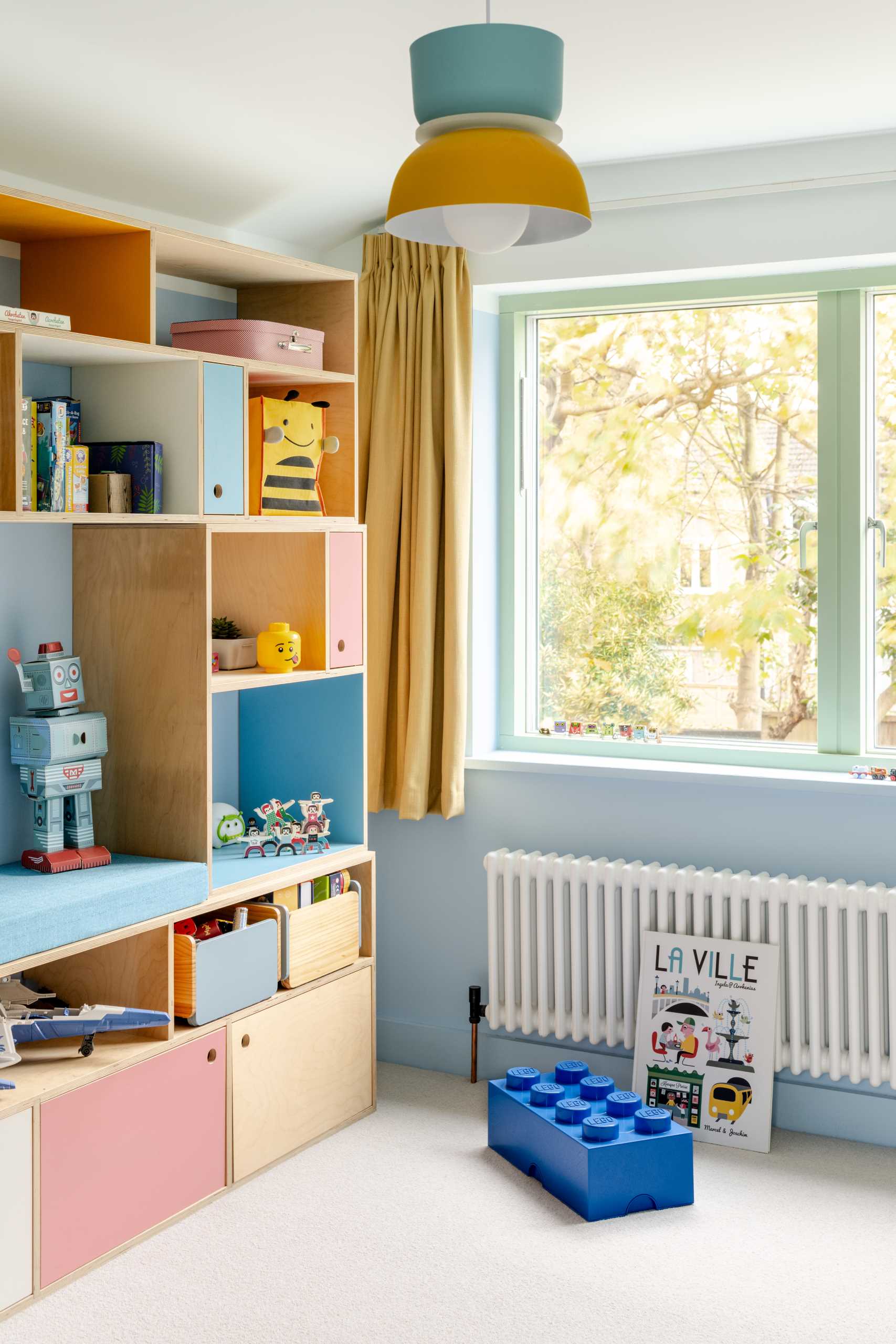 In the playroom, a bookcase with mostly open shelving provides an abundance of storage.