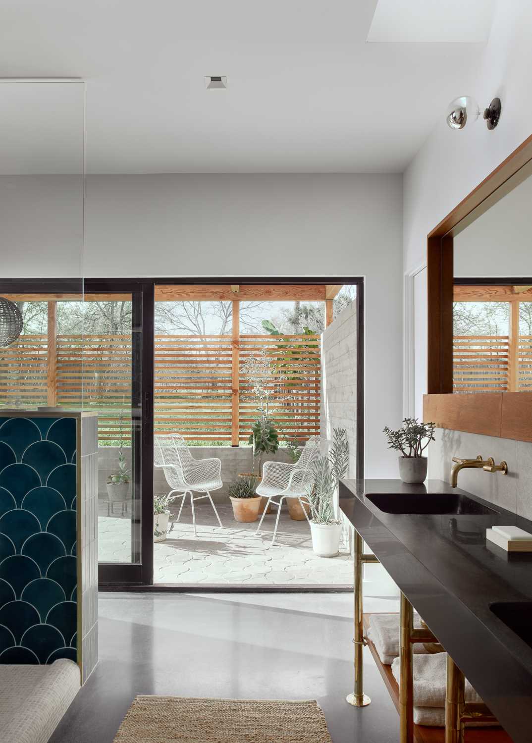 The primary bathroom features a contemporary design, and spills out to a private trellised patio.