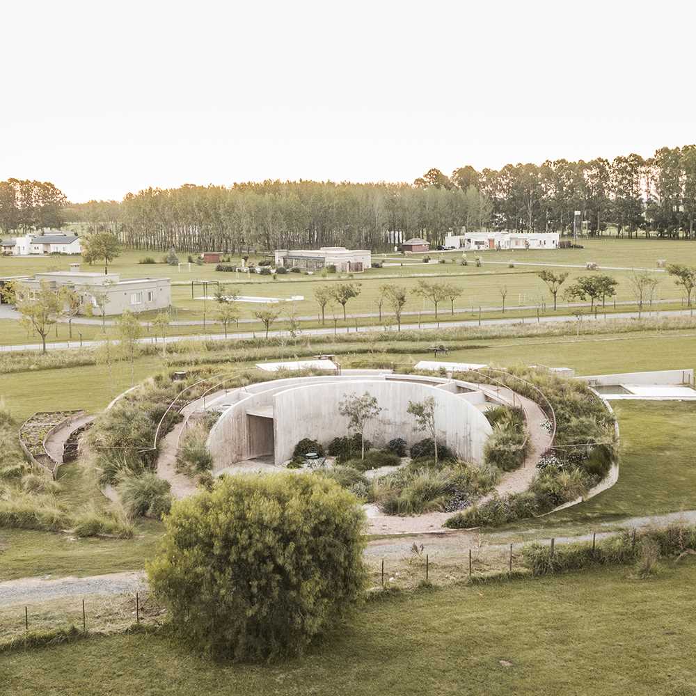 A curving contemporary home with a green roof, whose design was inspired by geometry and its surroundings.