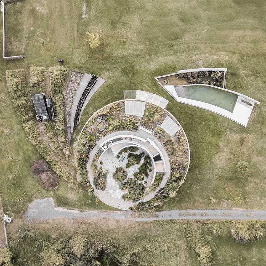 A curving contemporary home with a green roof, whose design was inspired by geometry and its surroundings.