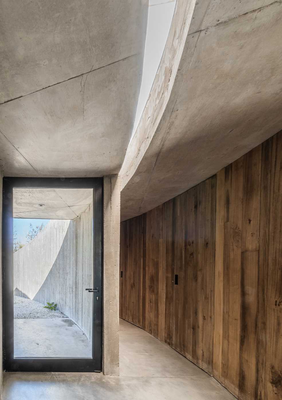 A curving contemporary home with a green roof, whose design was inspired by geometry and its surroundings.