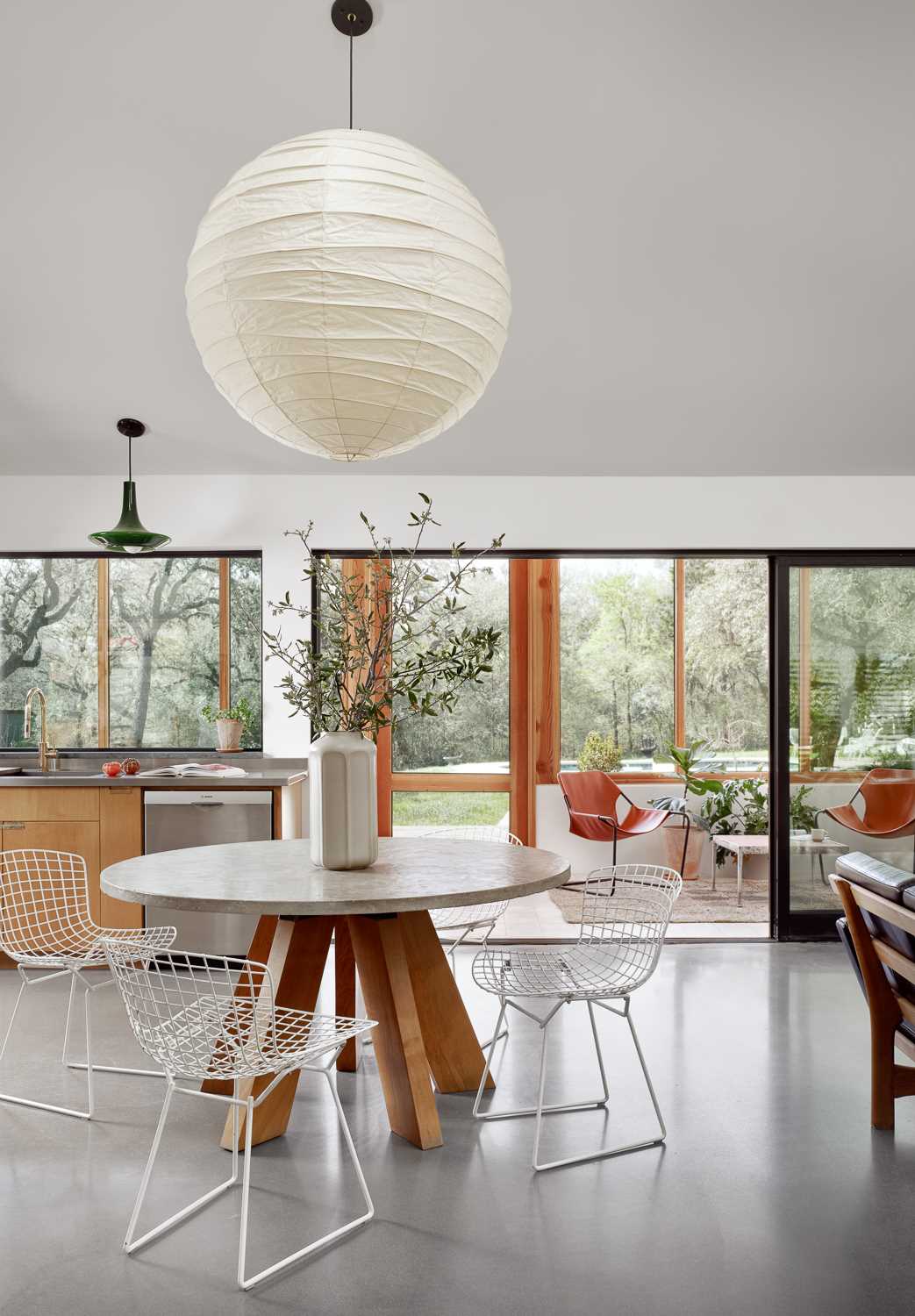 The dining area and kitchen share the same space as the living room. The kitchen features a soapstone countertop and backsplash, while the adjacent large butlers pantry was remodelled from the original space.