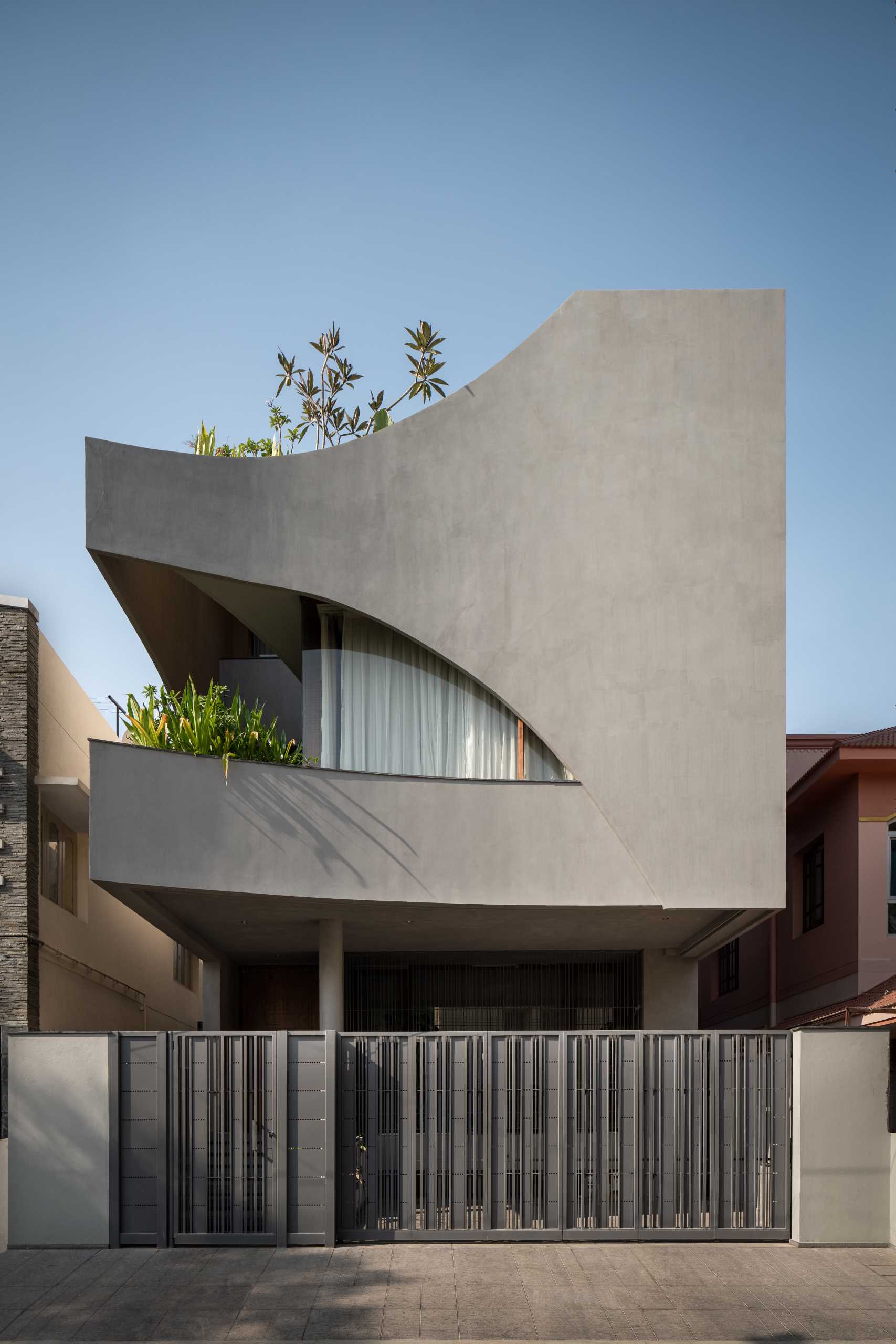 A modern home that features a cube design with cut-out sections.