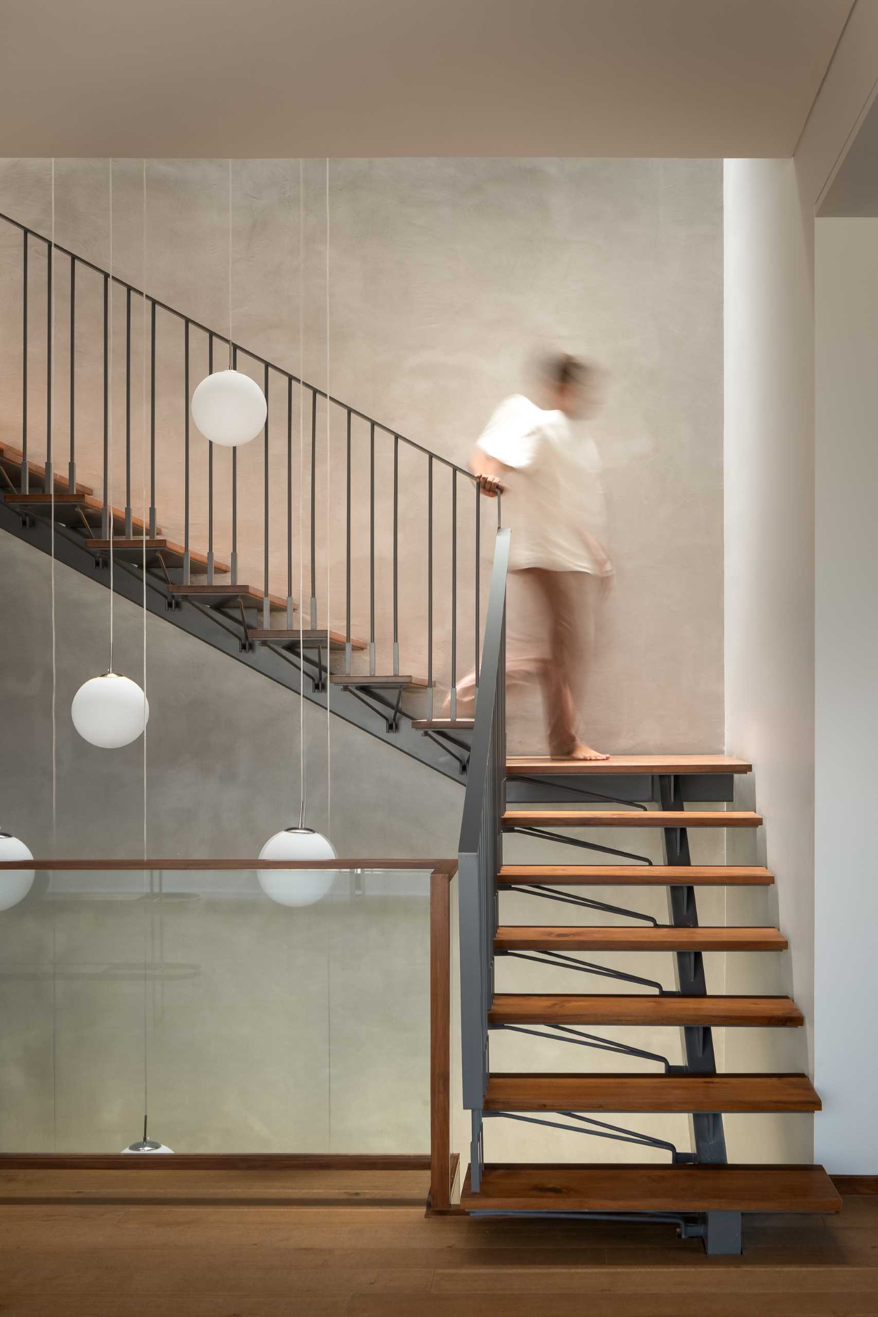 Wood and steel stairs connect the various levels of this modern home.