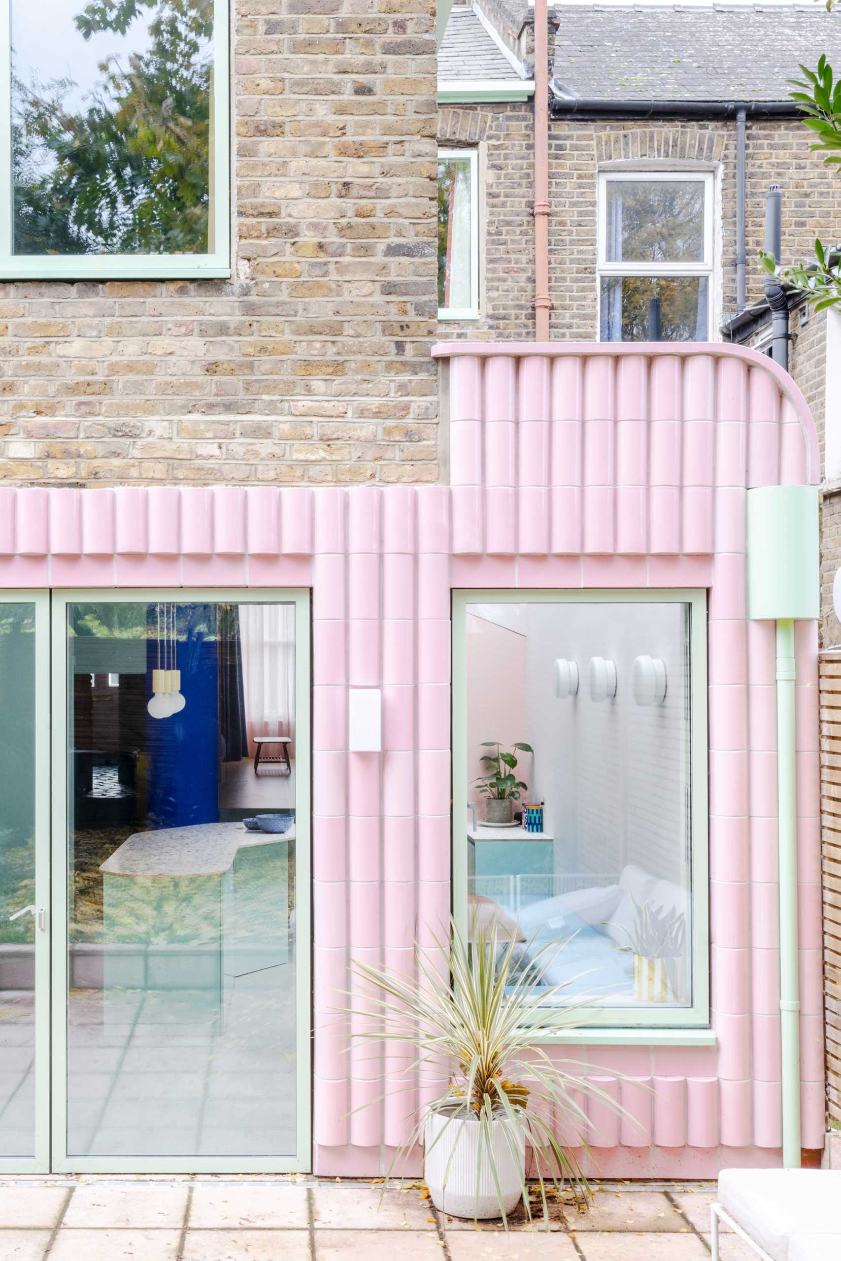 A contemporary addition full of colour and clad in handmade glazed tiles in pastel pink.