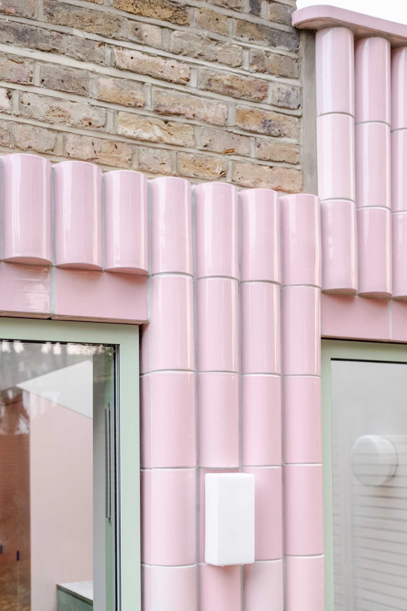 A contemporary addition full of colour and clad in handmade glazed tiles in pastel pink.