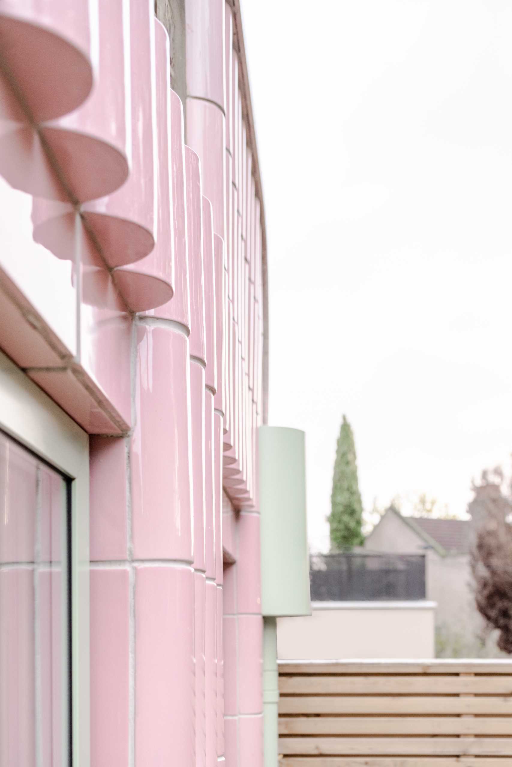 A contemporary addition full of colour and clad in handmade glazed tiles in pastel pink.