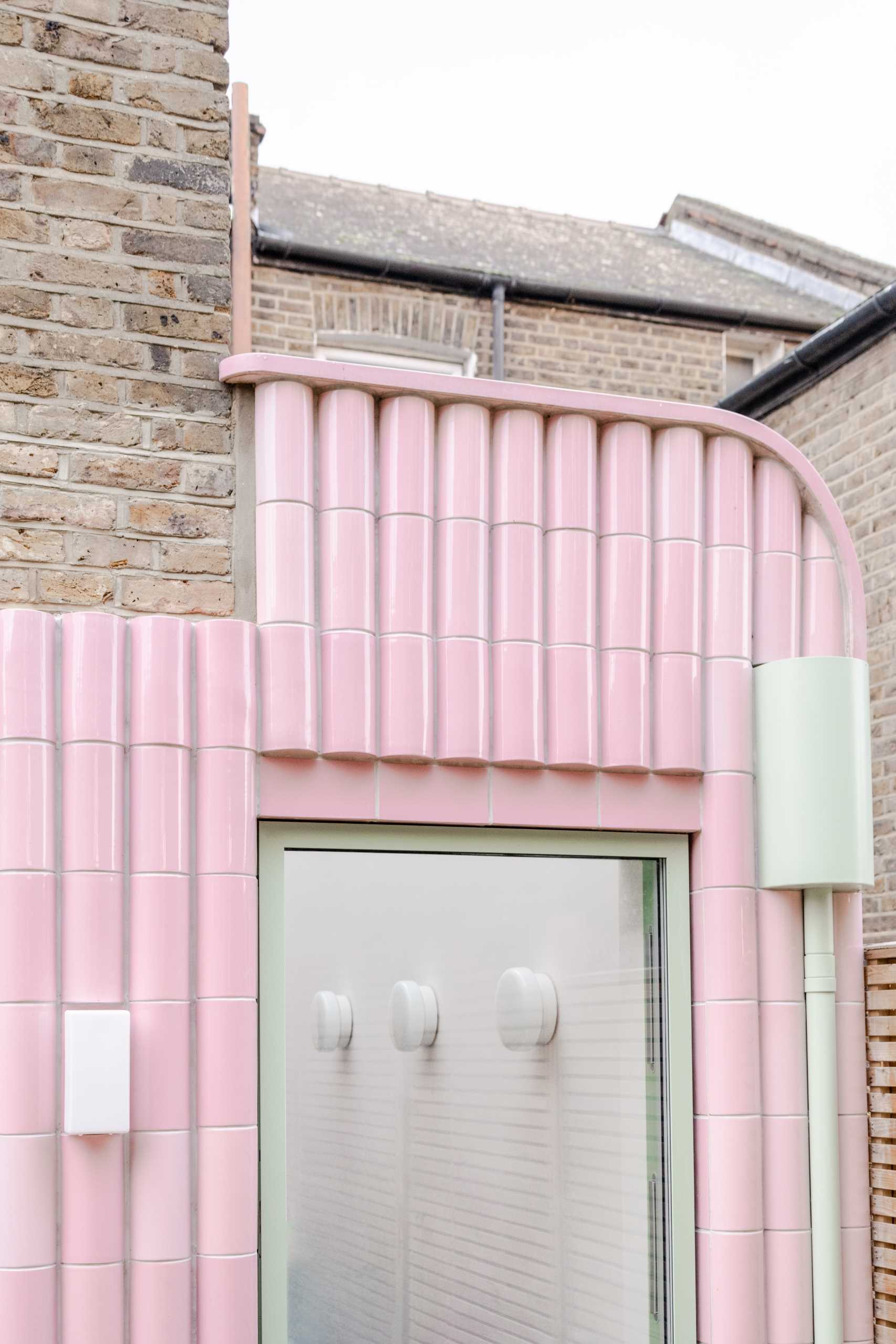 A contemporary addition full of colour and clad in handmade glazed tiles in pastel pink.