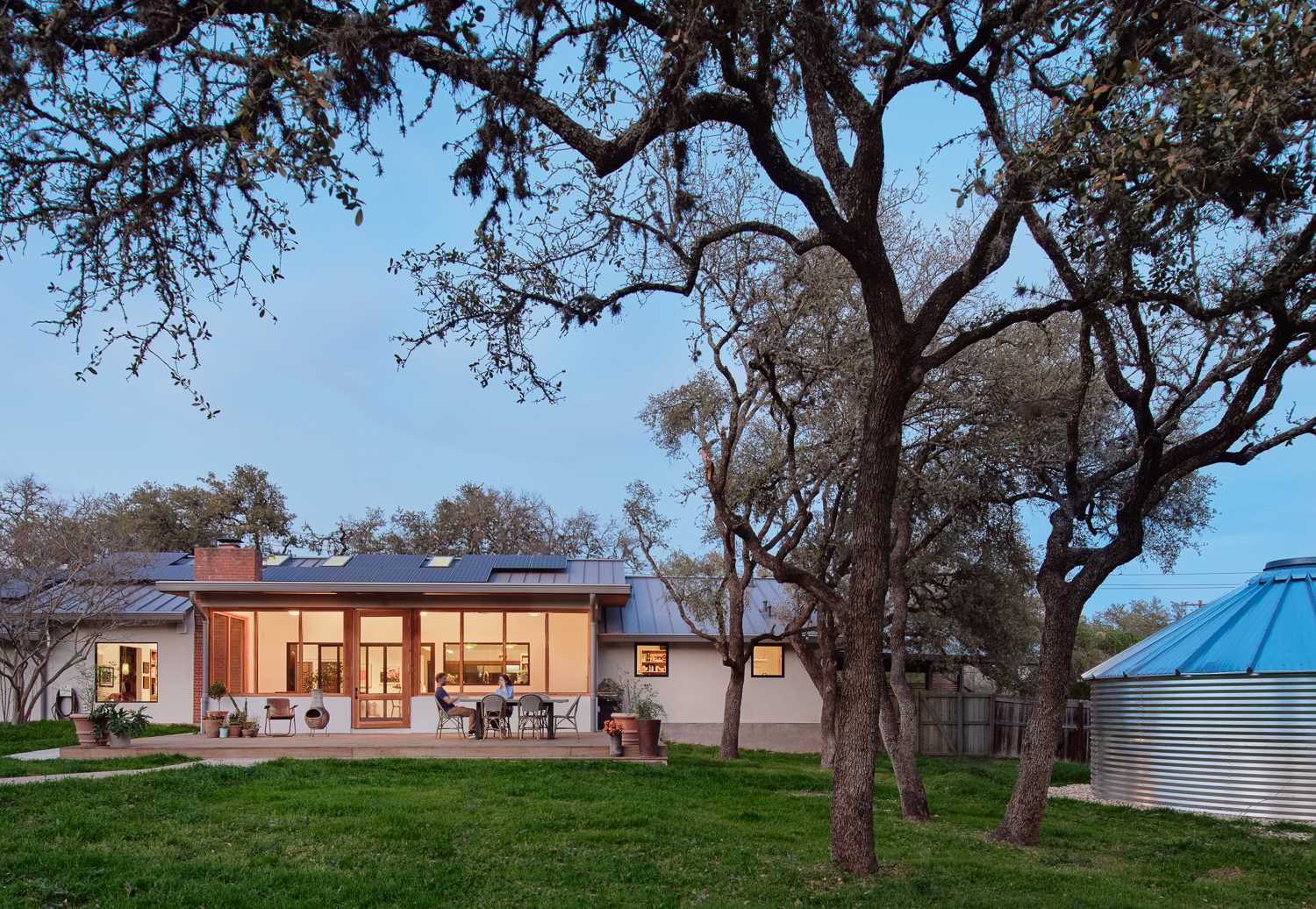 A long screened-in porch runs along the back of the house and expands the living space when the large glass sliding doors are fully retracted.