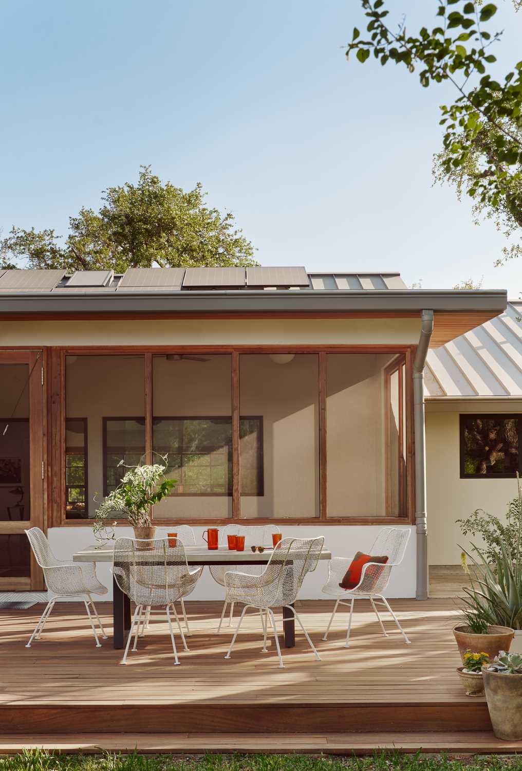 A long screened-in porch runs along the back of the house and expands the living space when the large glass sliding doors are fully retracted.