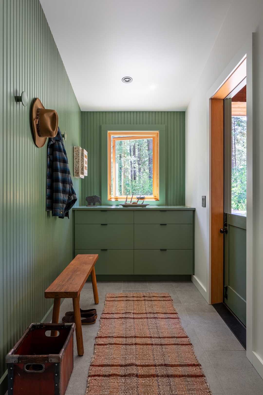 This entryway incorporates painted beadboard for a contemporary yet rural cabin aesthetic.