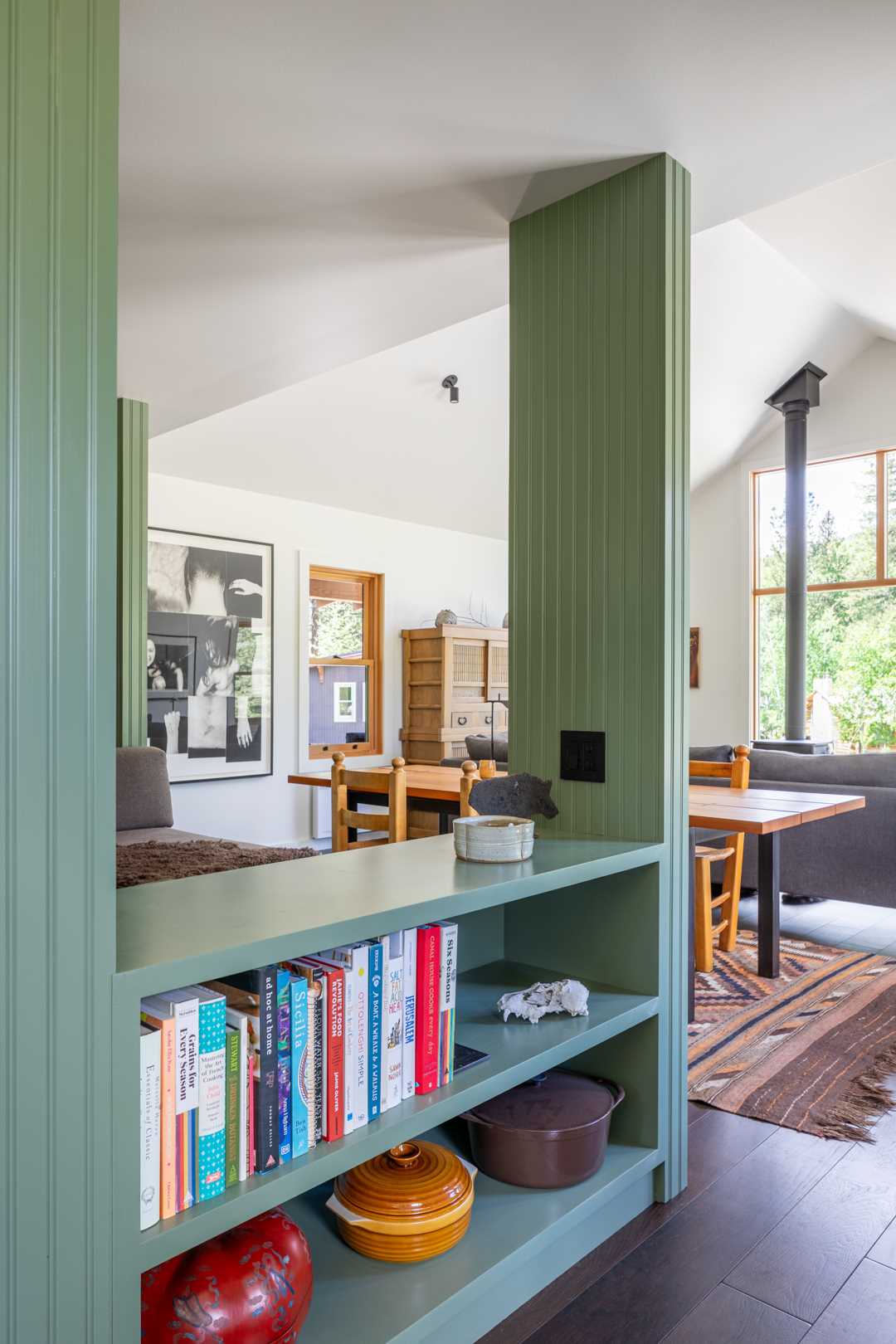 A small secluded home with a built-in day bed nook and bookshelves.