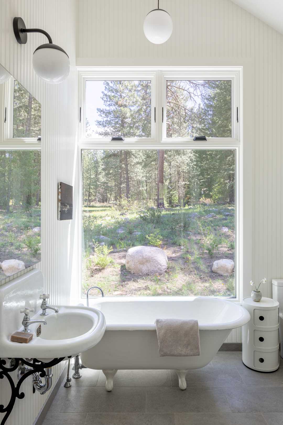 In this bathroom, white has been chosen as the main color for the interior, while black accents create contrasting elements.