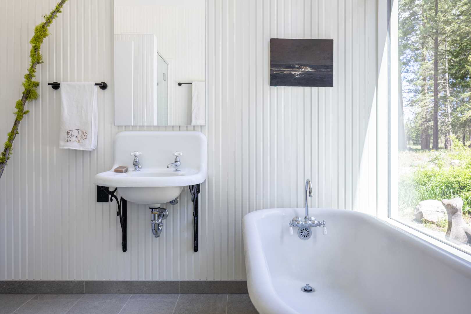 In this bathroom, white has been chosen as the main color for the interior, while black accents create contrasting elements.