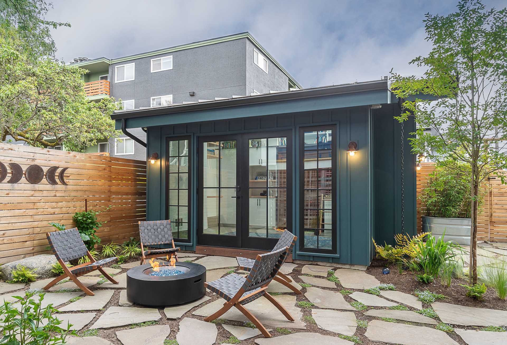 A pair of backyard cottages designed as a home office and a yoga studio.