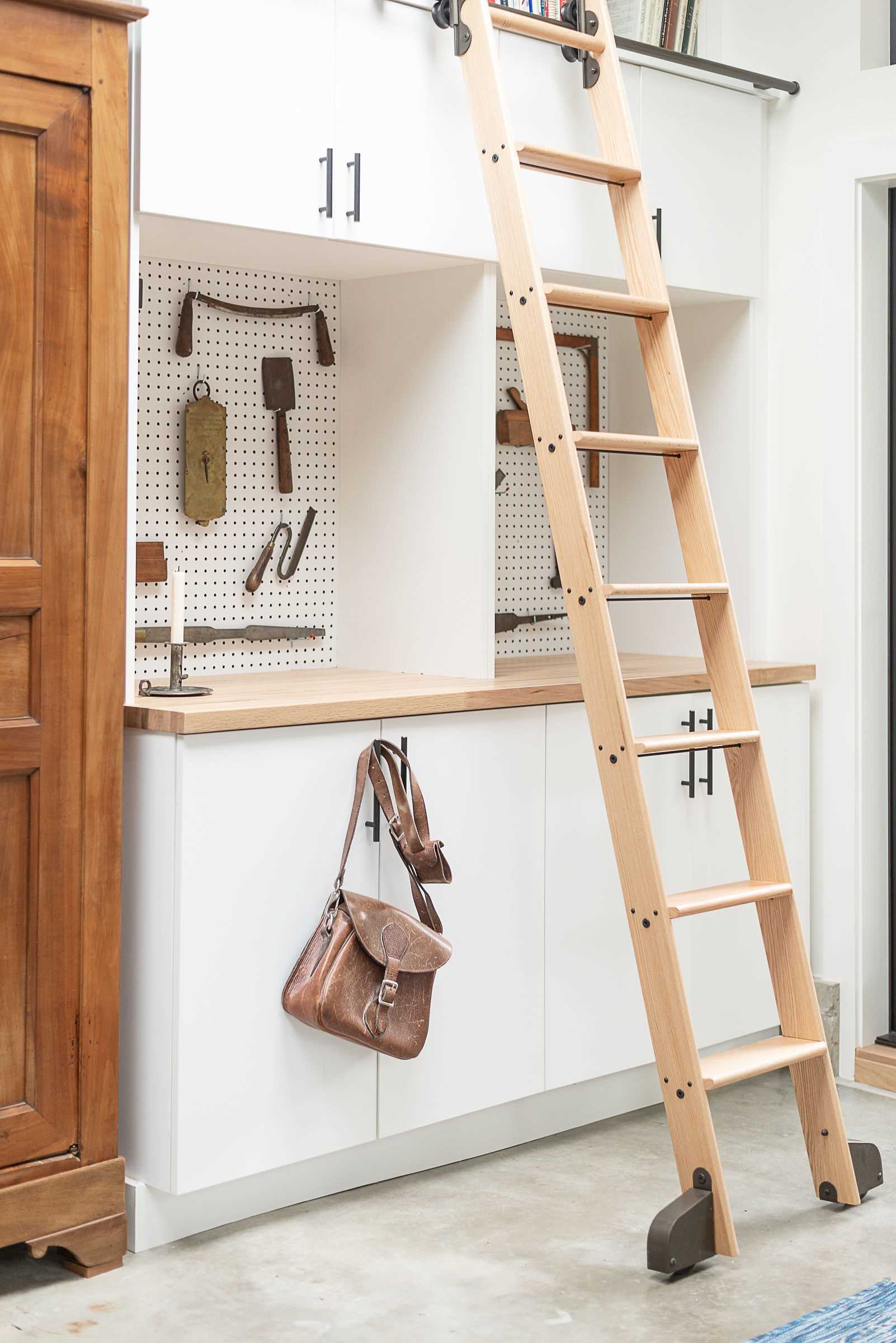 A backyard cottage designed as a home office includes a rolling ladder.