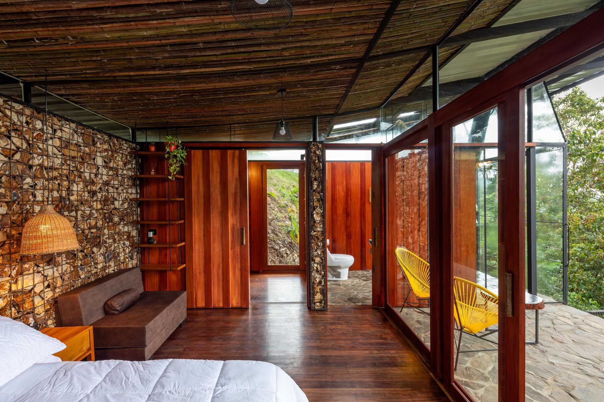 A room in the jungle includes a sleeping area, bathroom, and a balcony.