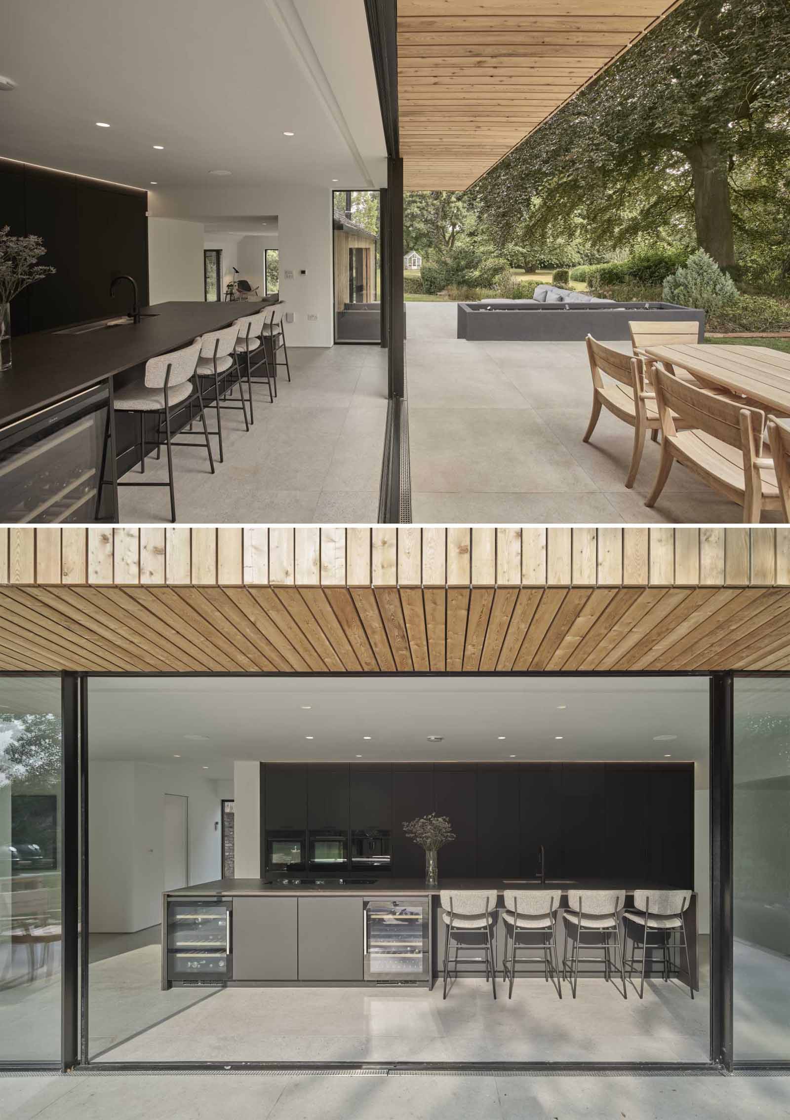 The cantilevered first floor shelters the expansive glass sliding doors below that connect the kitchen with the patio.