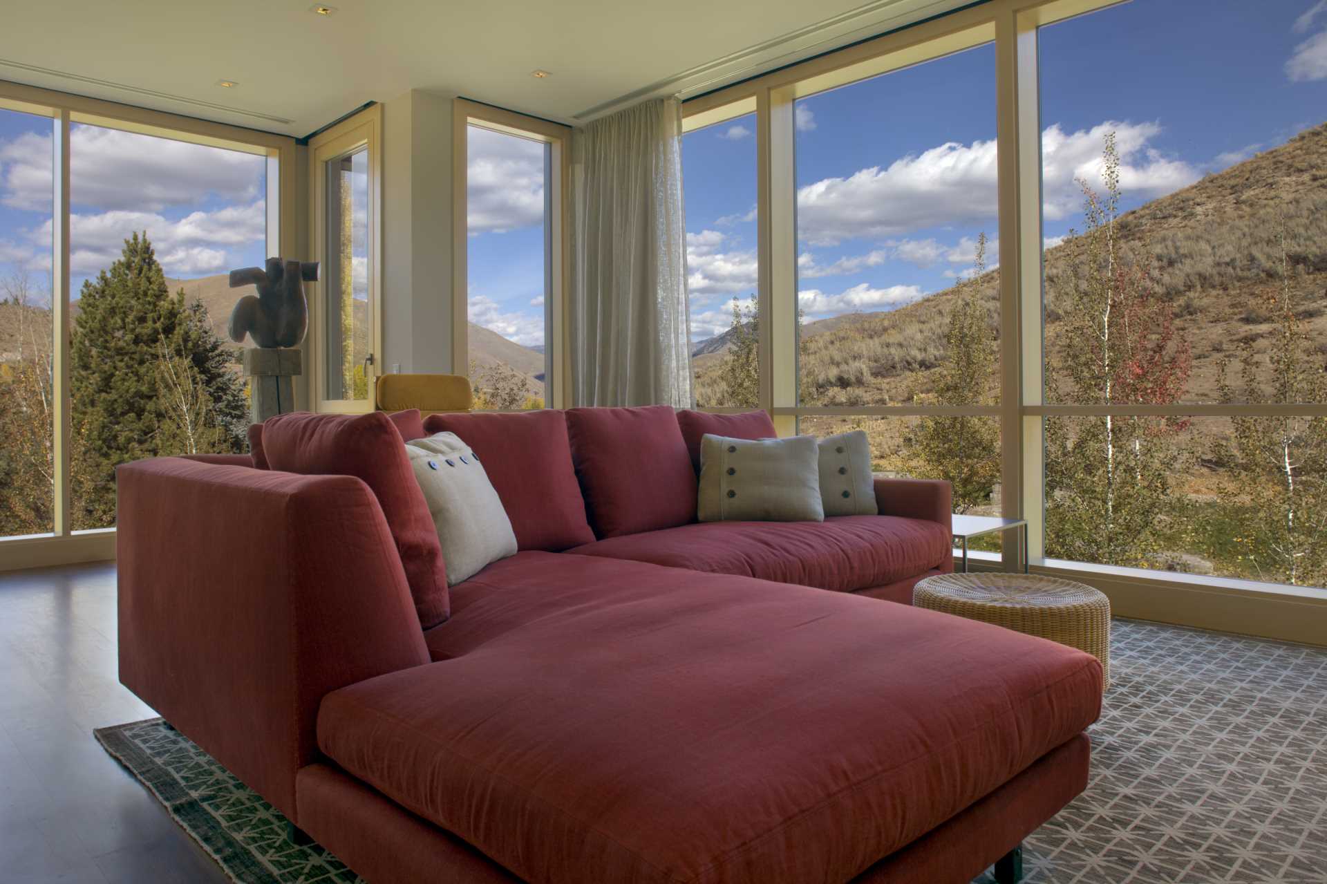 A contemporary living room with a red couch.