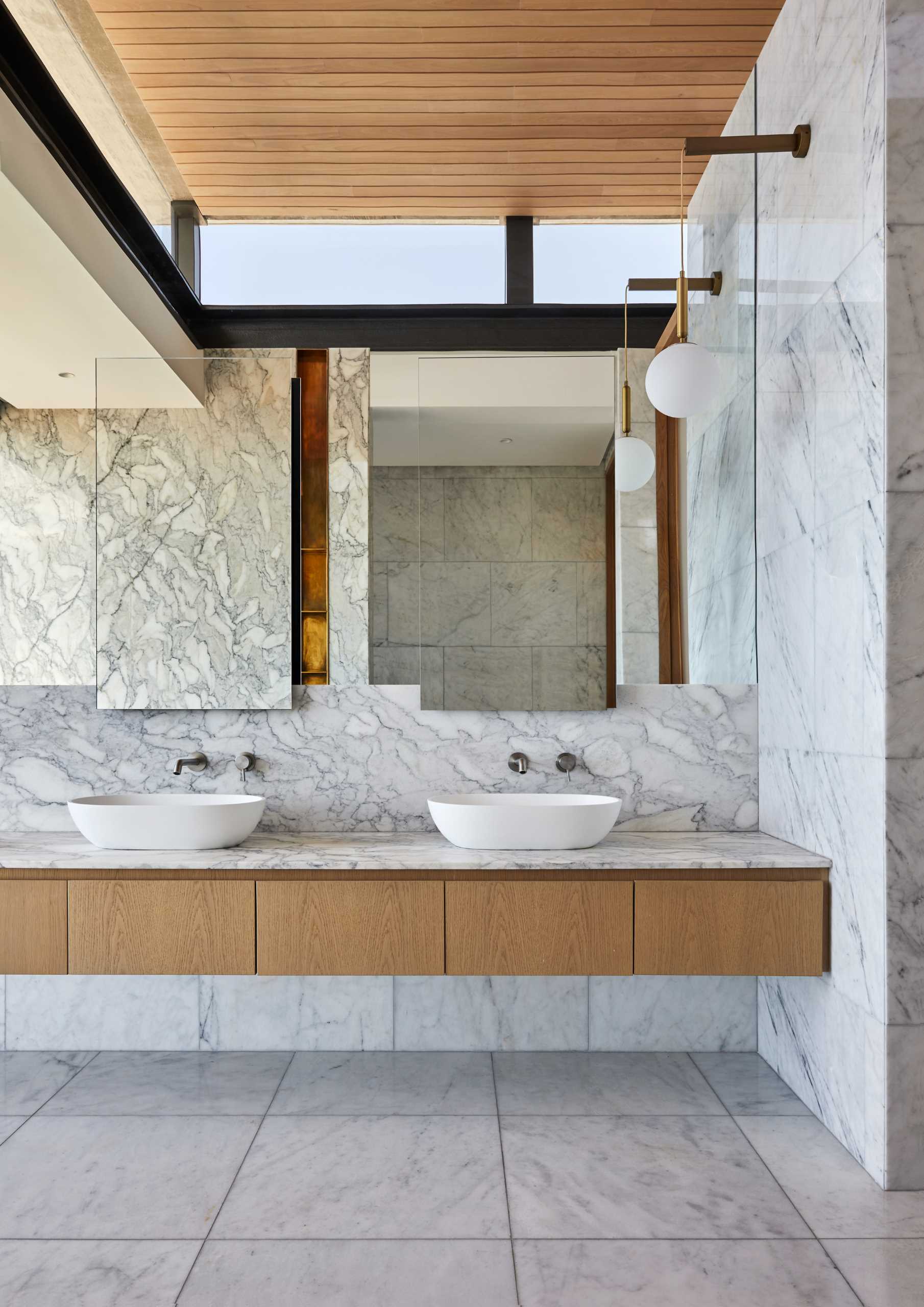 A modern bathroom with large format tiles and a floating vanity.