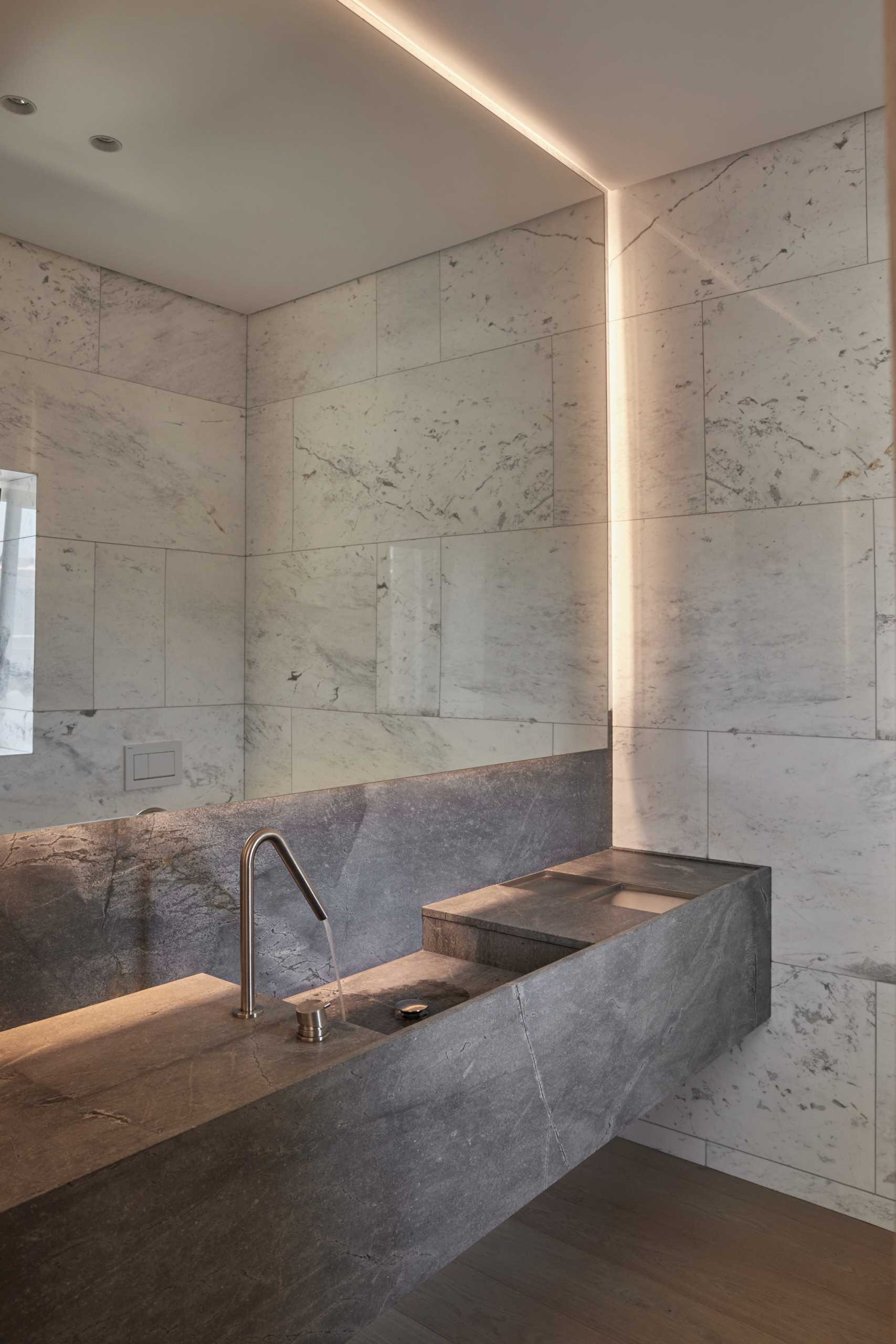 A modern bathroom with a backlit mirror.