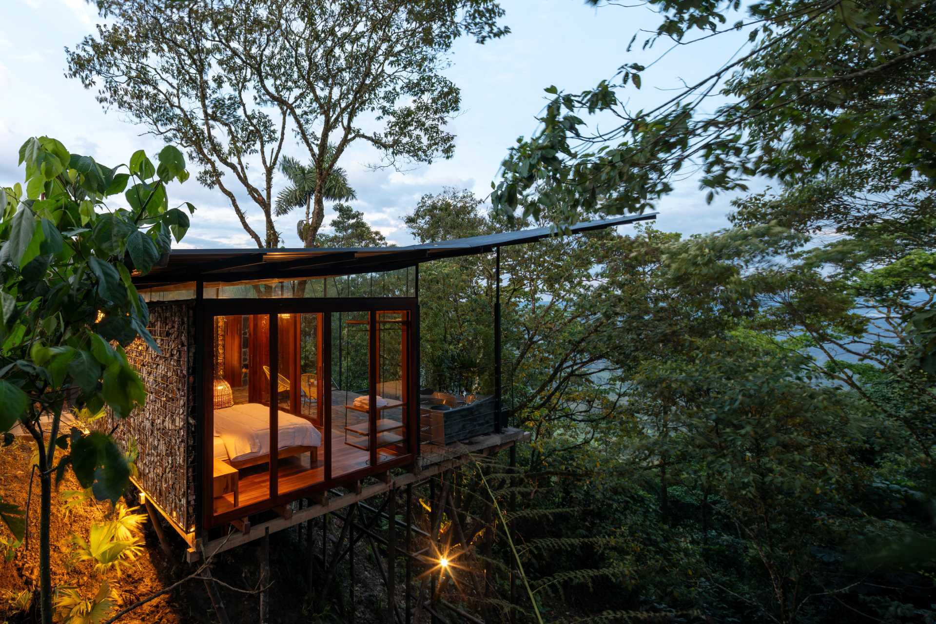 A room in the jungle includes a sleeping area, bathroom, and a balcony.