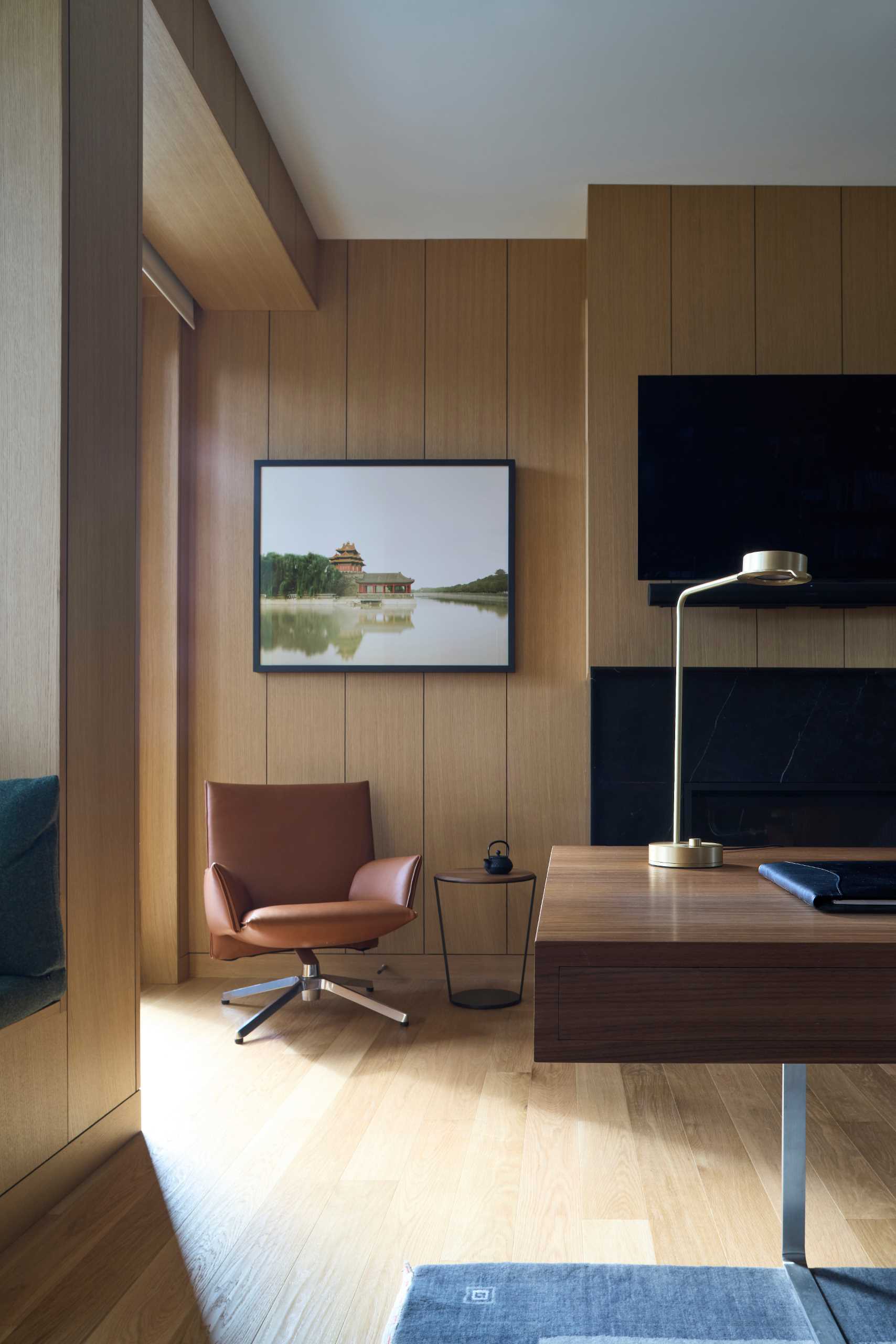 A modern home office with wood walls.