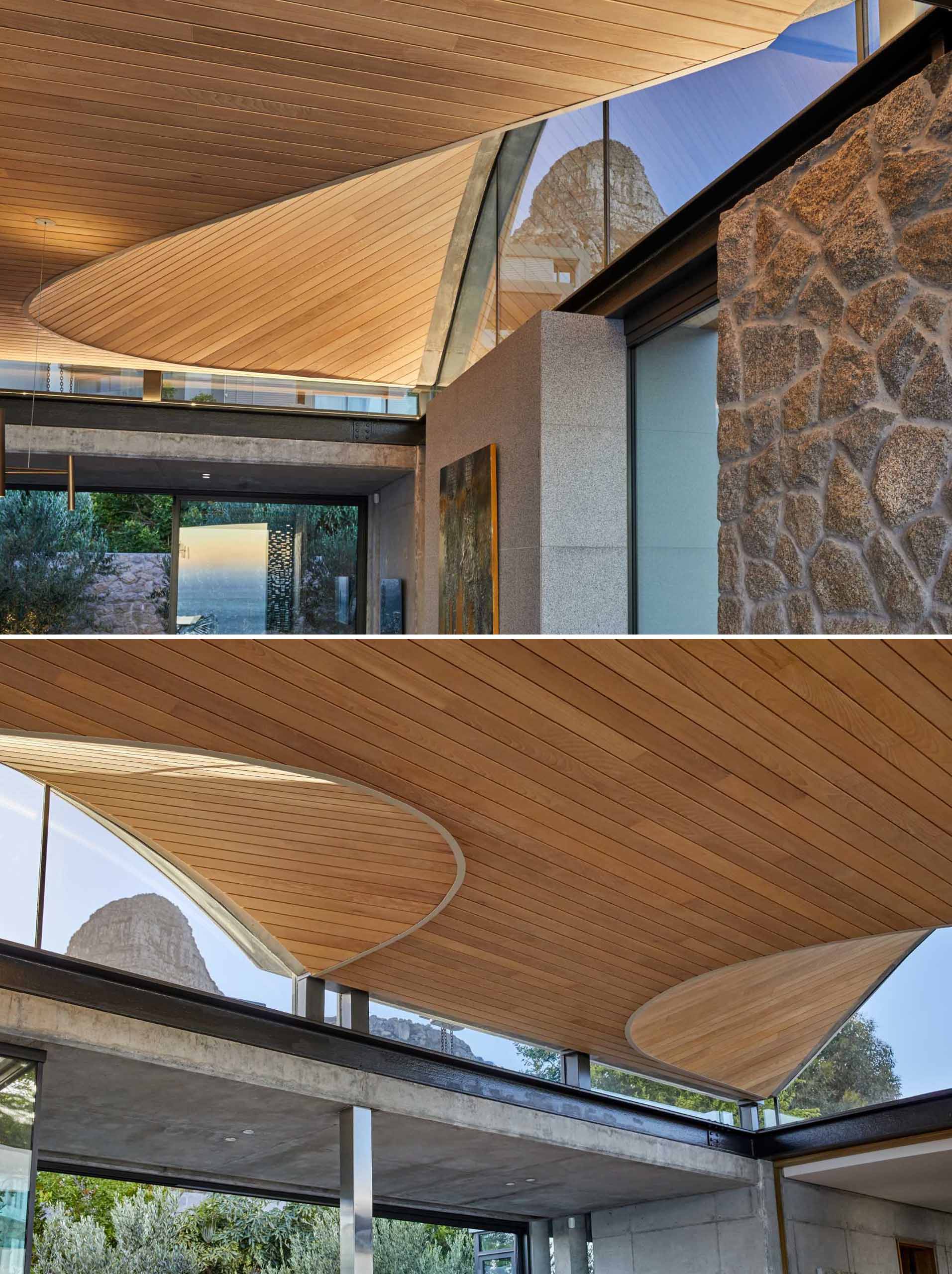 A modern home interior with clerestory windows and an undulating wood-lined ceiling.