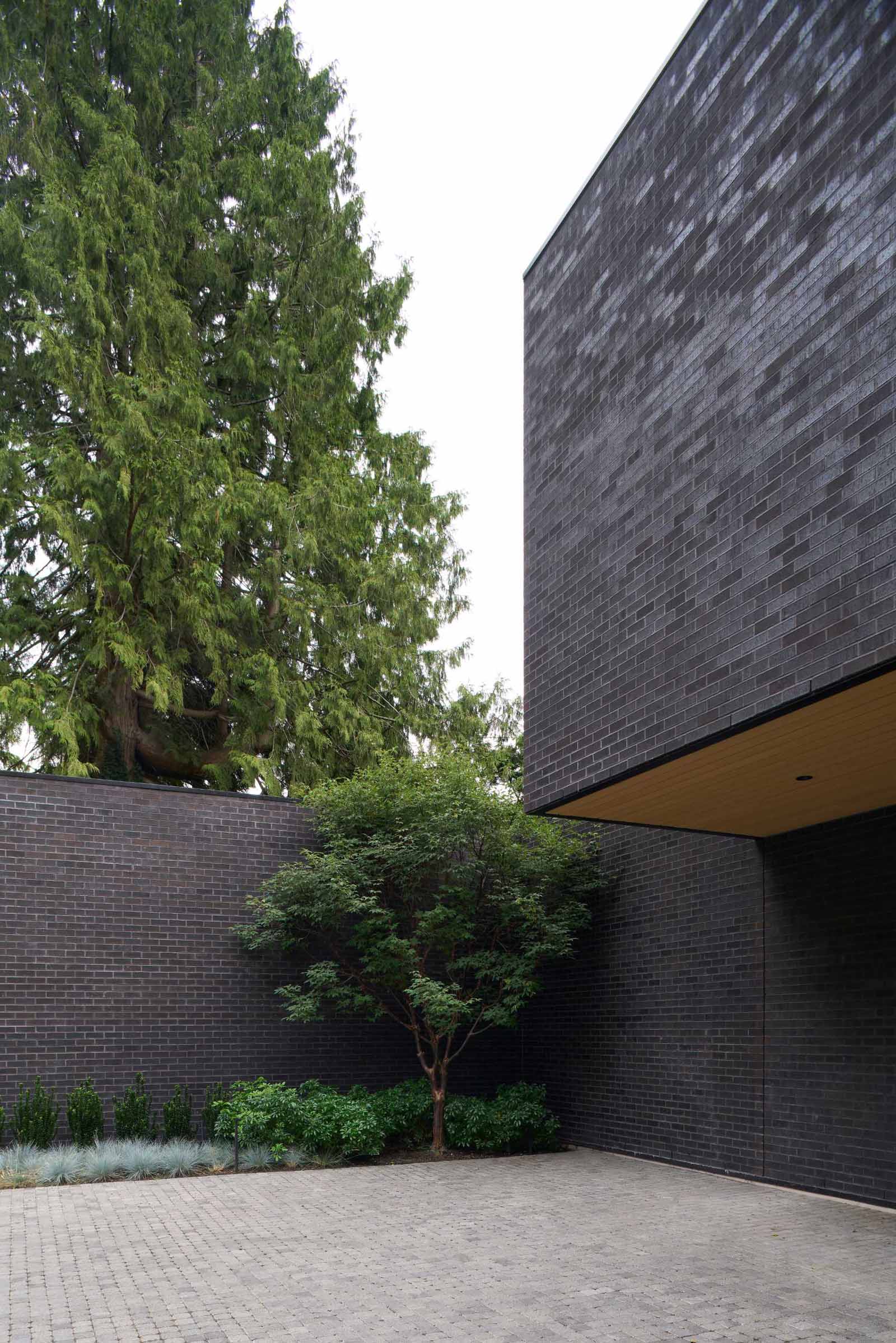 A modern house with a dark brick exterior.