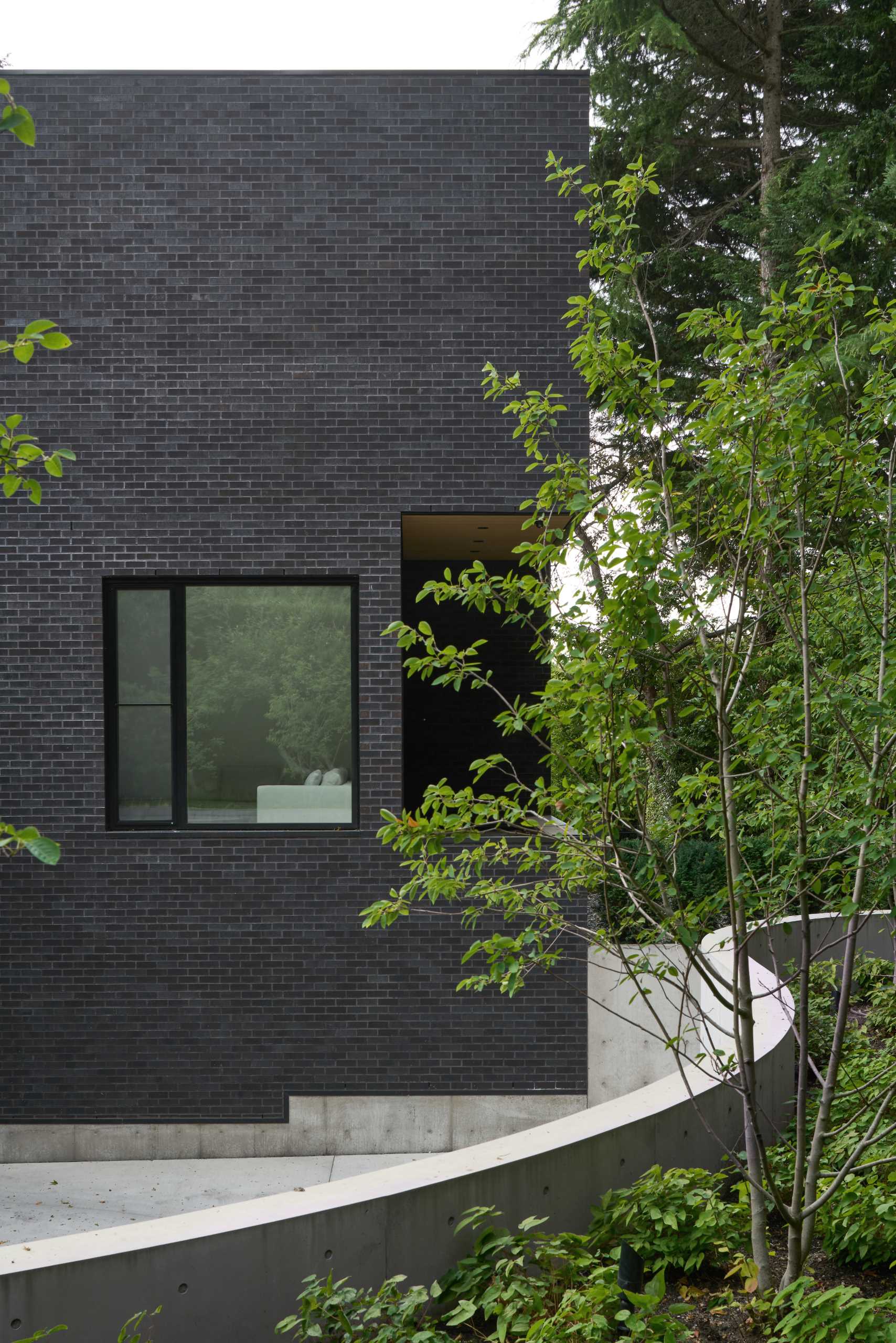 A modern house with a dark brick exterior.