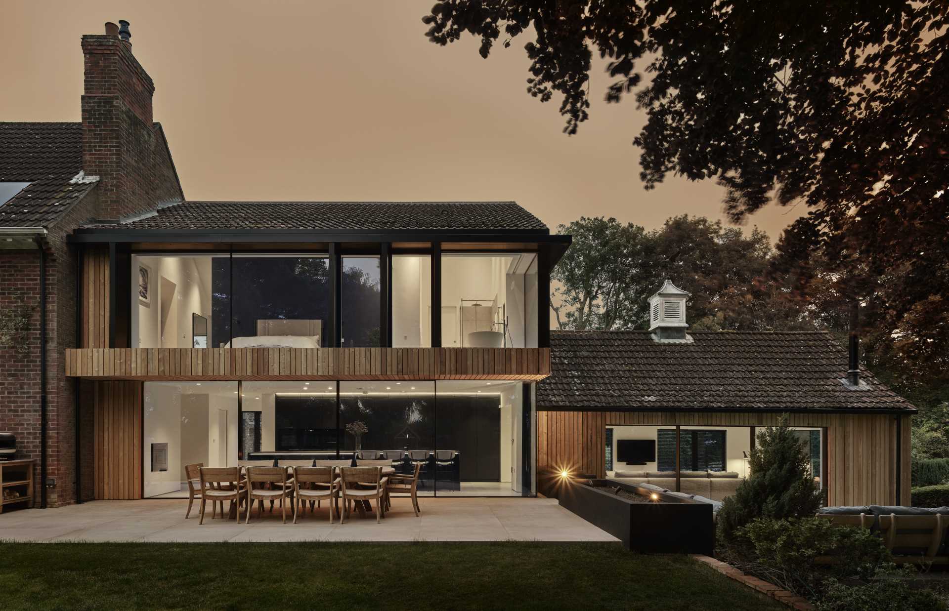 An old brick home received a new wood-clad two-storey extension with a contemporary interior.