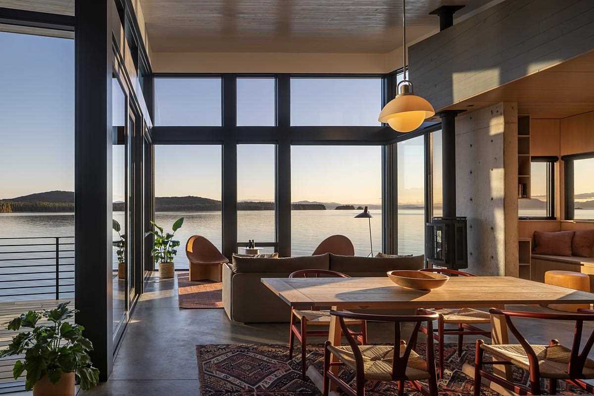 Floor-to-ceiling windows in this living room draw the eye to the view beyond and give the interior spaces an outward directionality.