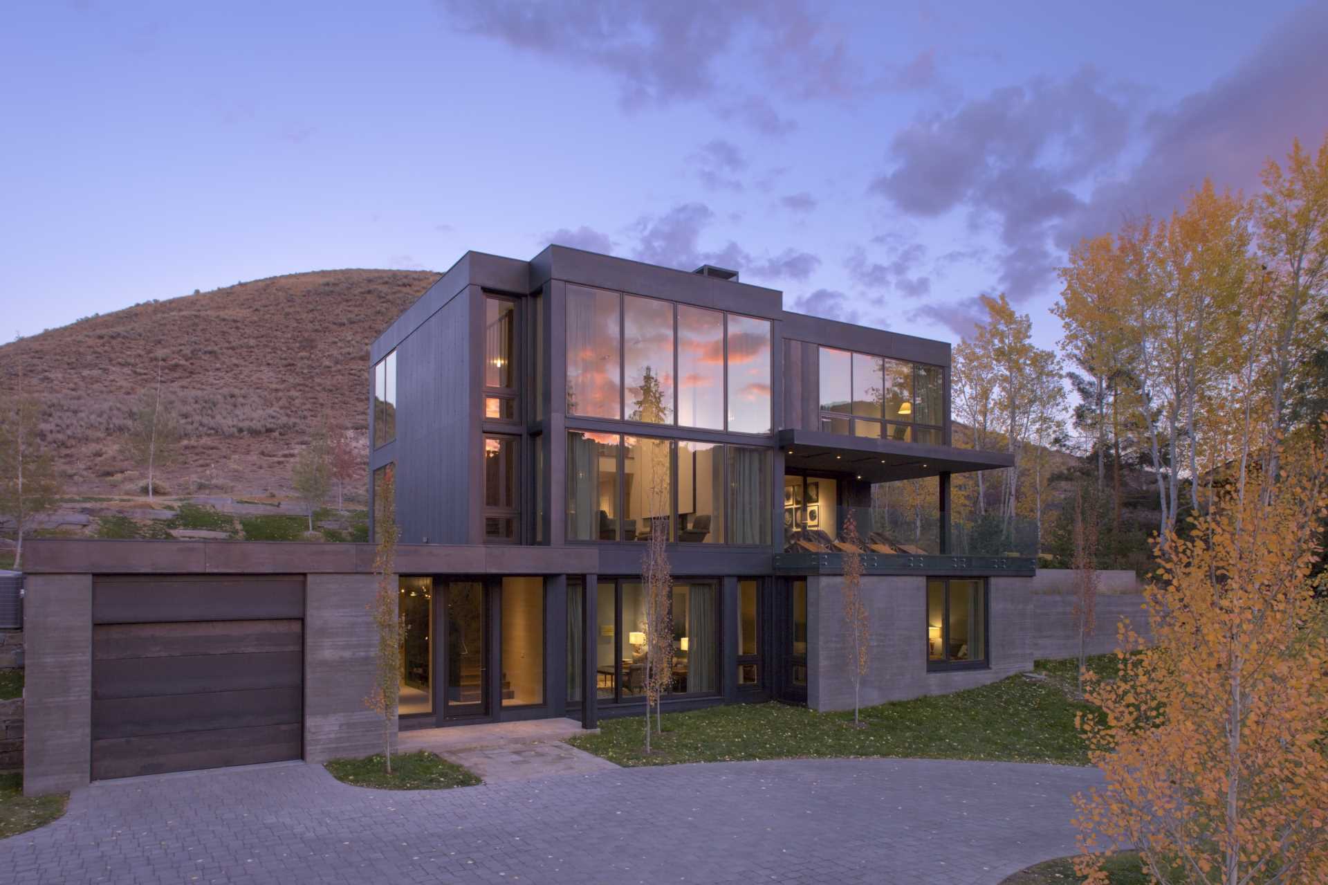 The sheet metal skin of oiled steel was selected for the siding of this modern home to bring in the dark tones of the stone masses that had been so inspirational in the design of the home.