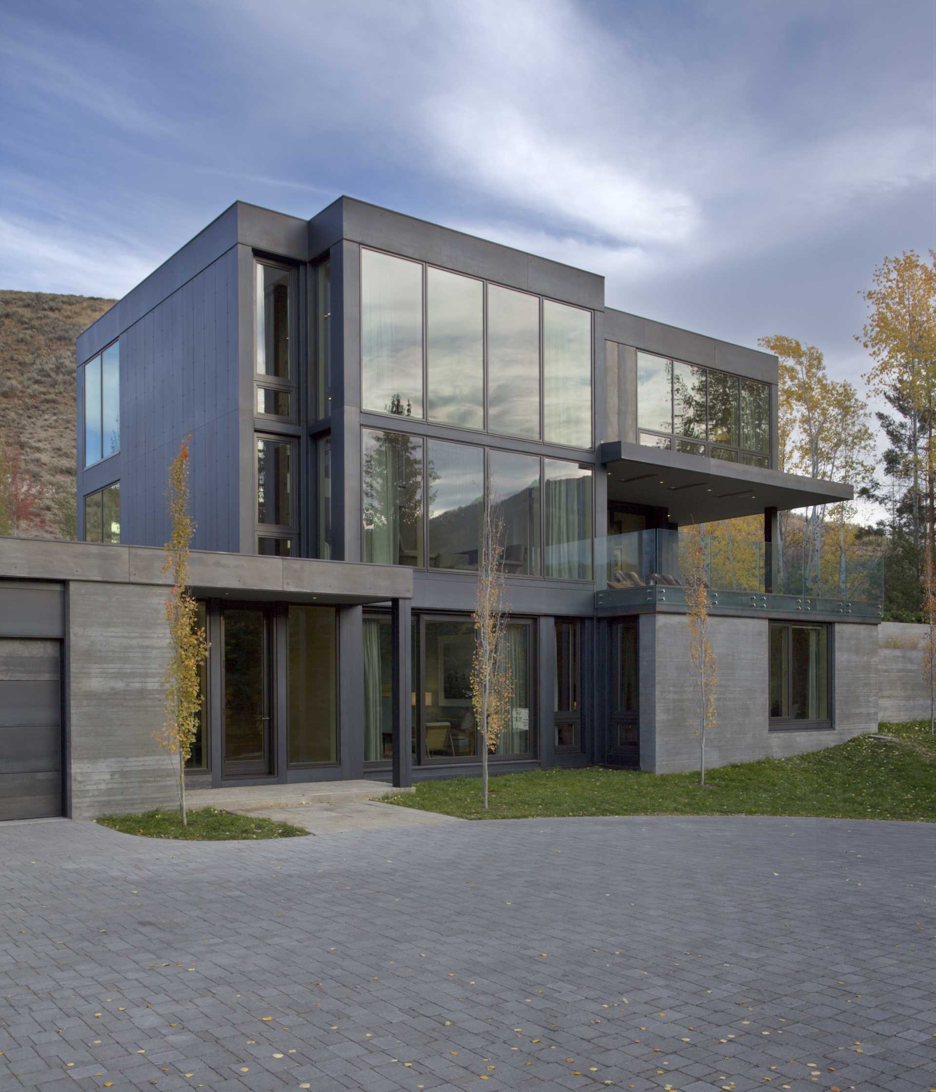 The sheet metal skin of oiled steel was selected for the siding of this modern home to bring in the dark tones of the stone masses that had been so inspirational in the design of the home.