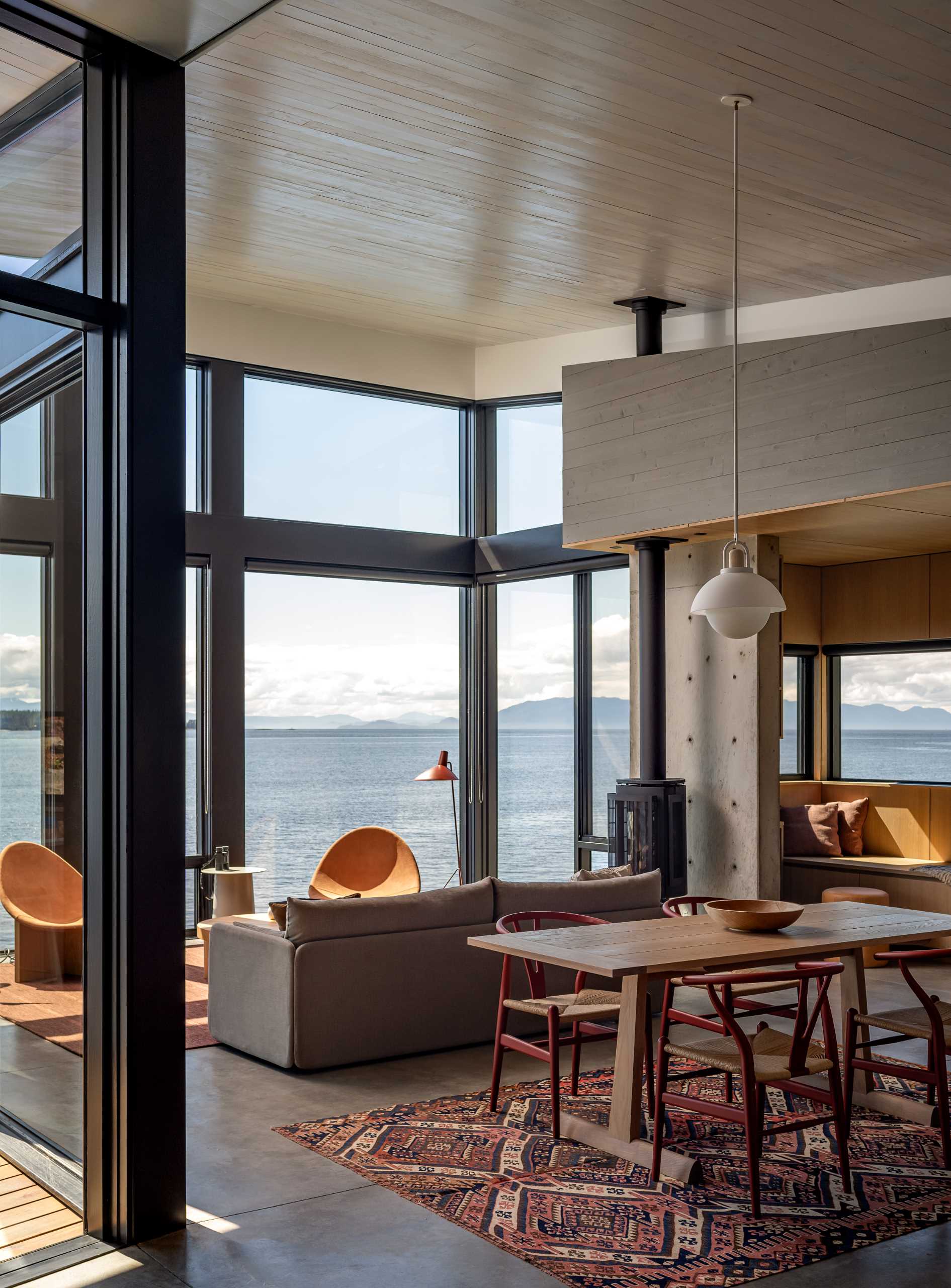 Floor-to-ceiling windows in this living room draw the eye to the view beyond and give the interior spaces an outward directionality.