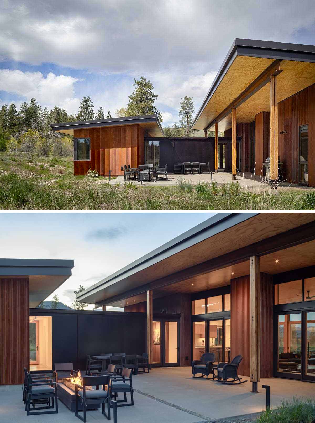 Between the two areas of this contemporary home is a partially covered patio with a dining area and an space for sitting around an outdoor fire.