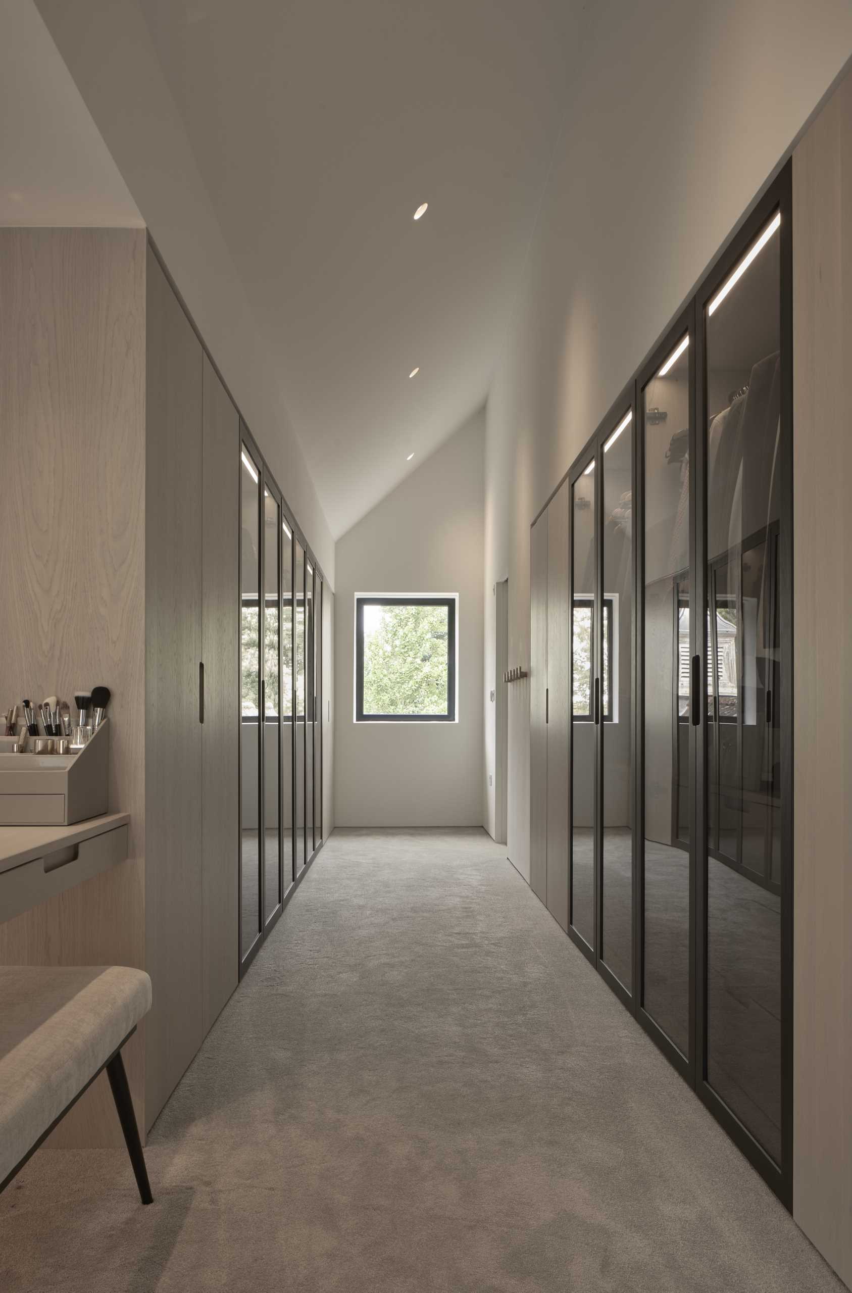 A private dressing area and walk-in wardrobe are tucked subtly behind the primary bedroom wall, adding to the seamless elegance and thoughtful functionality of the design.