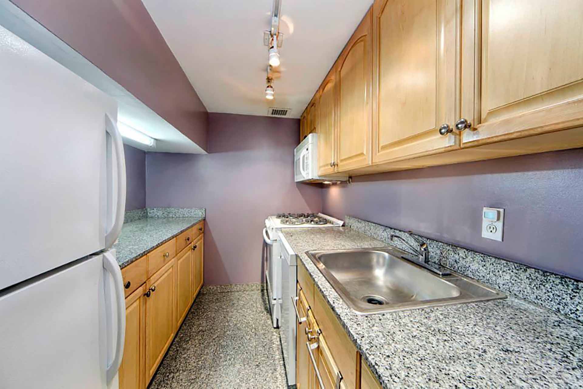 Before photo of a small loft apartment kitchen.