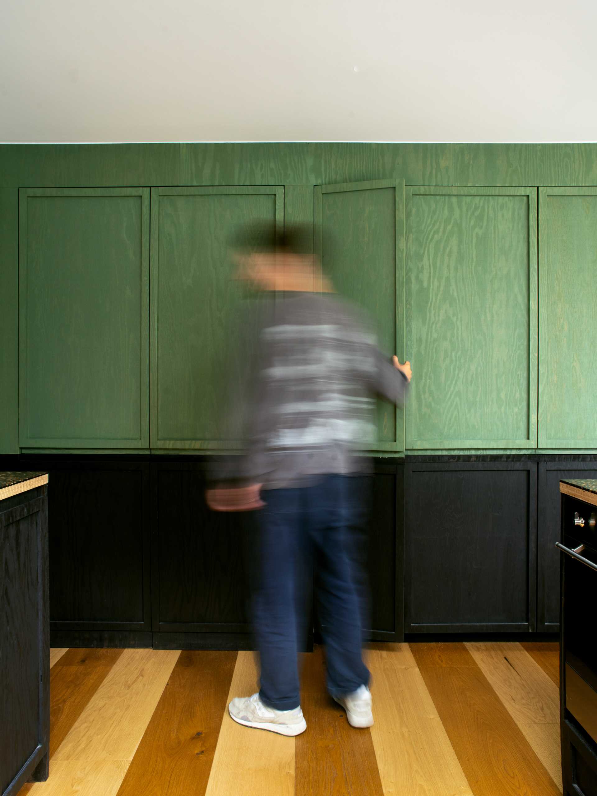 A modern home extension with a curved window, a skylight, and a new dining area and custom kitchen with IKEA cabinets.