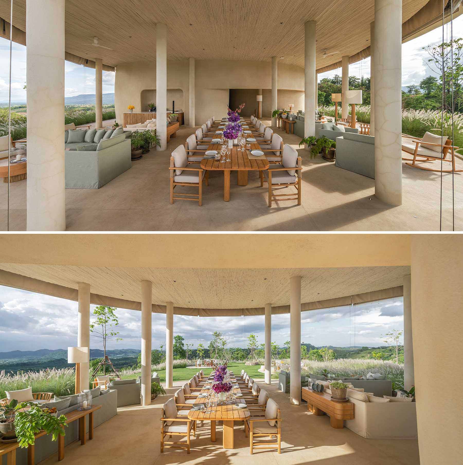 An open-air pavilion features earth tone colours and a ceiling made of bamboo. The pavilion is home to a variety of casual seating areas and a large central dining table.