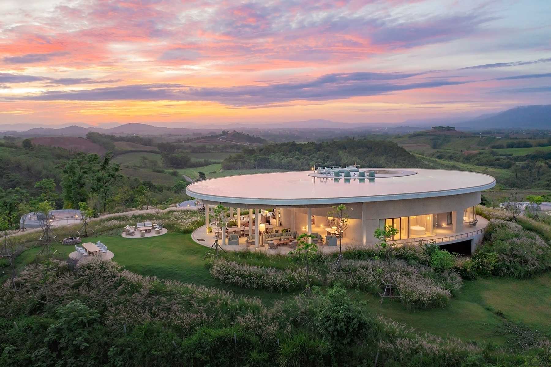 The various building designs of this boutique hotel are inspired by the silhouette of surrounding mountains, the contours of the landscape, and the organic characteristics of the site.