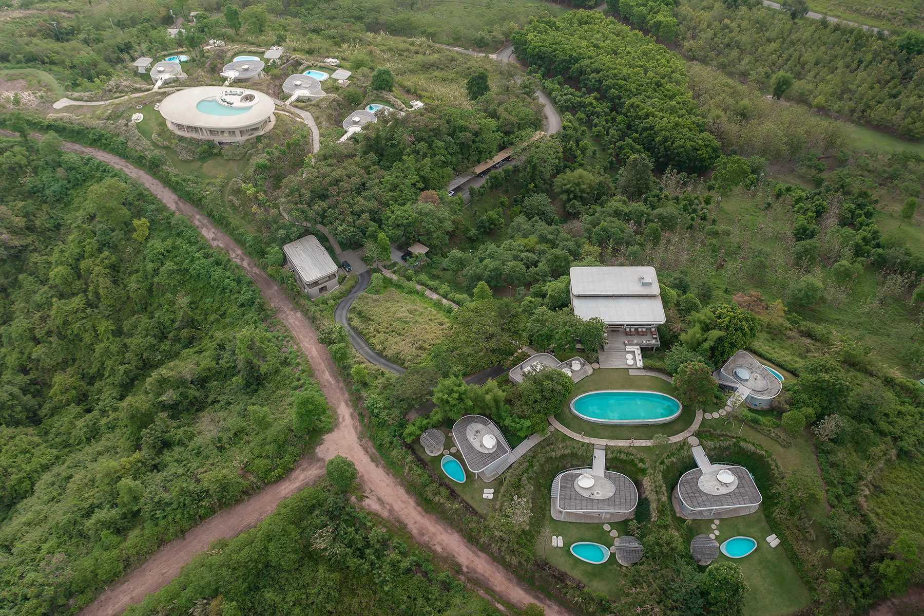 The various building designs of this boutique hotel are inspired by the silhouette of surrounding mountains, the contours of the landscape, and the organic characteristics of the site.