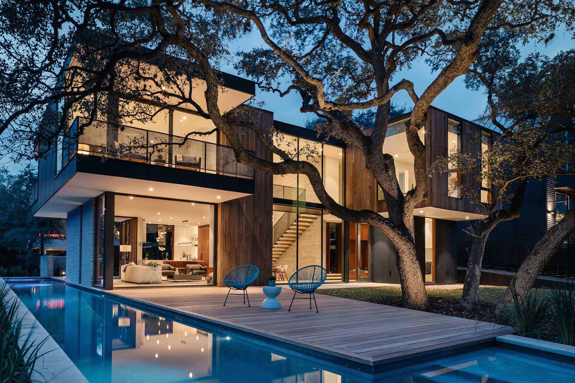 A modern home designed around a split-trunk live oak that's stood guard over the center of the tight lot for decades.