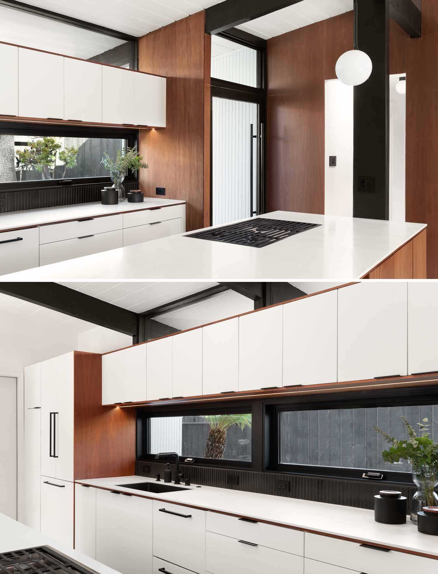 Wood, white, and black served as the clean palette for the new design of this  kitchen in a renovated mid-century modern home.