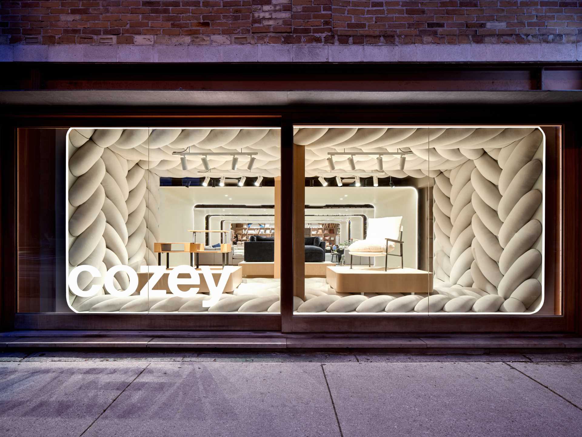 The design of this retail window showcase displays a giant fabric weave to draw pedestrians inside the space.